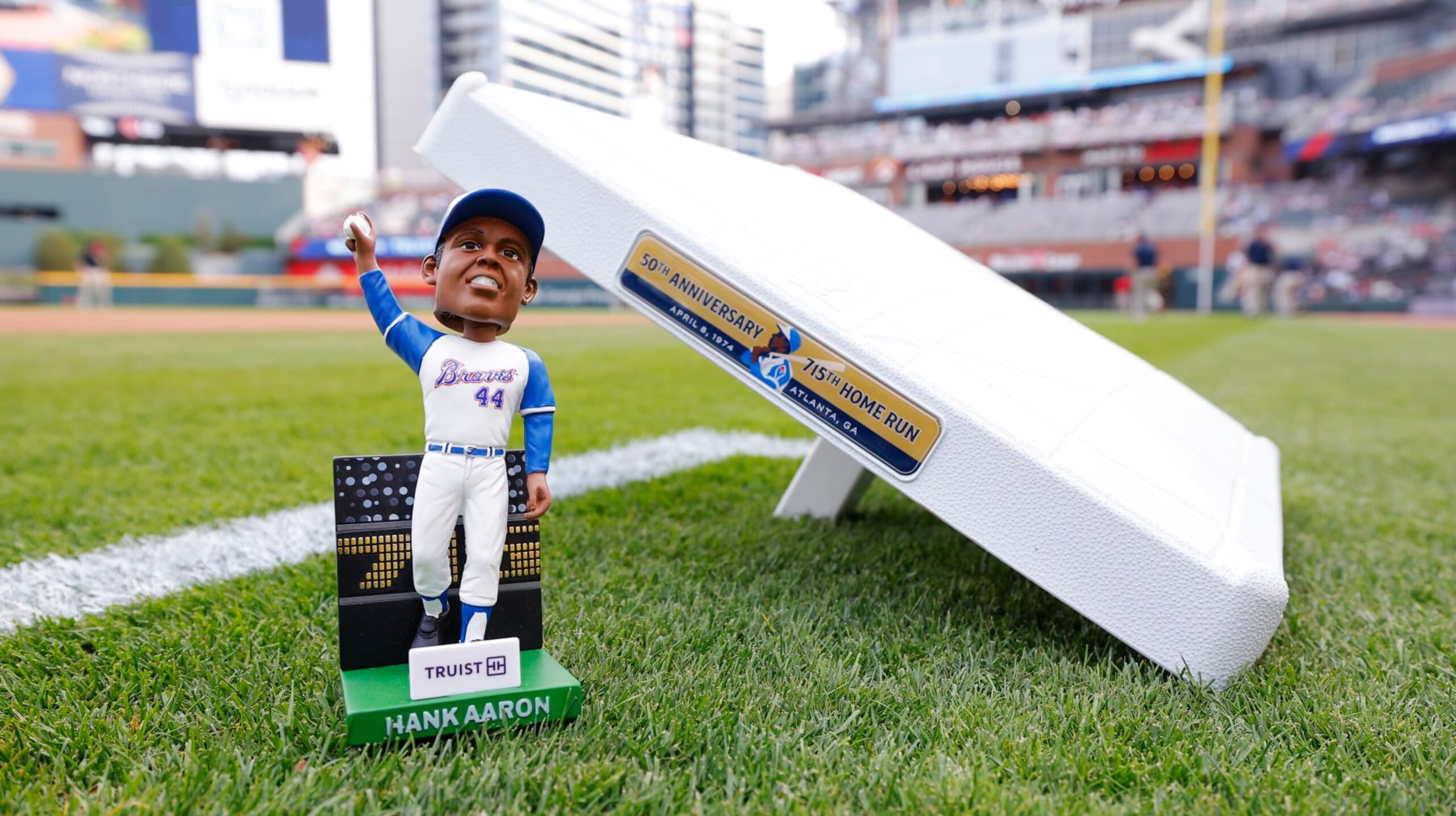 ATLANTA, GA - APRIL 08:  A detail view of the Hank Aaron '74 home run record bobblehead presented by Truist and commemorative base prior to the game between the New York Mets and the Atlanta Braves at Truist Park on Monday, April 8, 2024 in Atlanta, Georgia. (Photo by Todd Kirkland/MLB Photos via Getty Images)