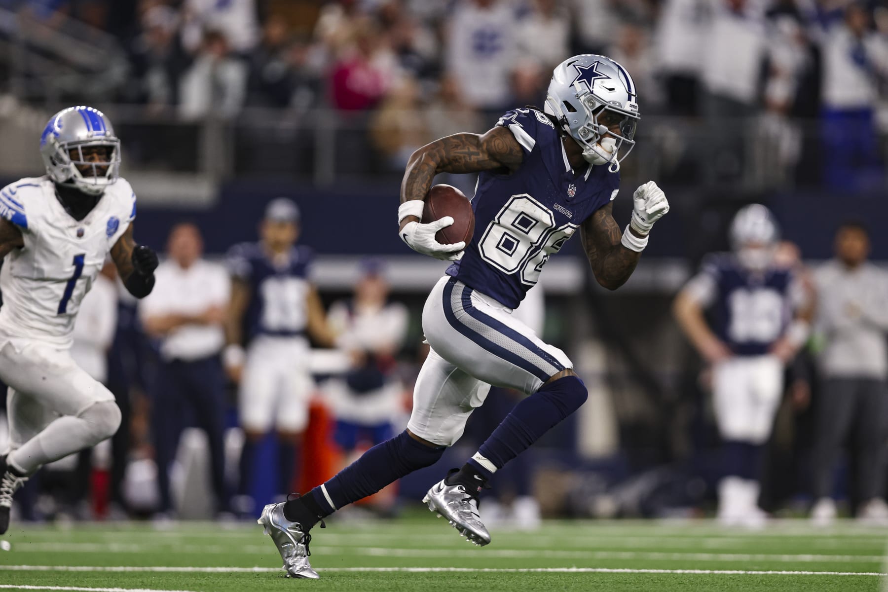 ARLINGTON, TX - DECEMBER 30: CeeDee Lamb #88 of the Dallas Cowboys runs with the ball during an NFL football game against the Detroit Lions at AT&T Stadium on December 30, 2023 in Arlington, Texas. (Photo by Perry Knotts/Getty Images)