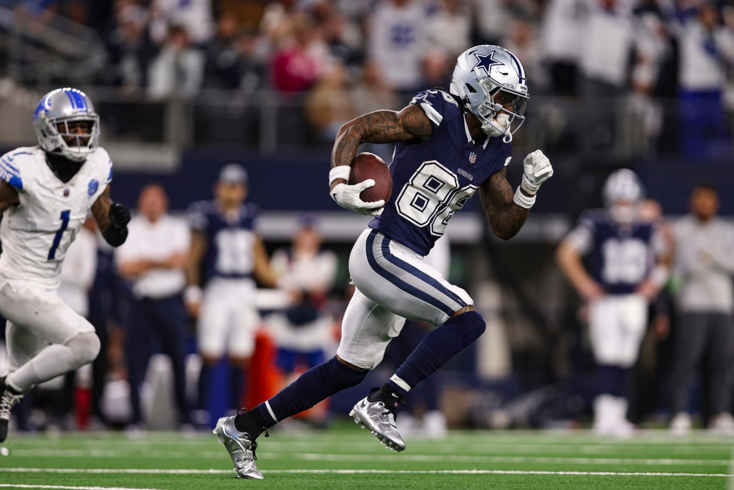 ARLINGTON, TX - DECEMBER 30: CeeDee Lamb #88 of the Dallas Cowboys runs with the ball during an NFL football game against the Detroit Lions at AT&T Stadium on December 30, 2023 in Arlington, Texas. (Photo by Perry Knotts/Getty Images) ARLINGTON, TX - DECEMBER 30: CeeDee Lamb #88 of the Dallas Cowboys runs with the ball during an NFL football game against the Detroit Lions at AT&T Stadium on December 30, 2023 in Arlington, Texas. (Photo by Perry Knotts/Getty Images)