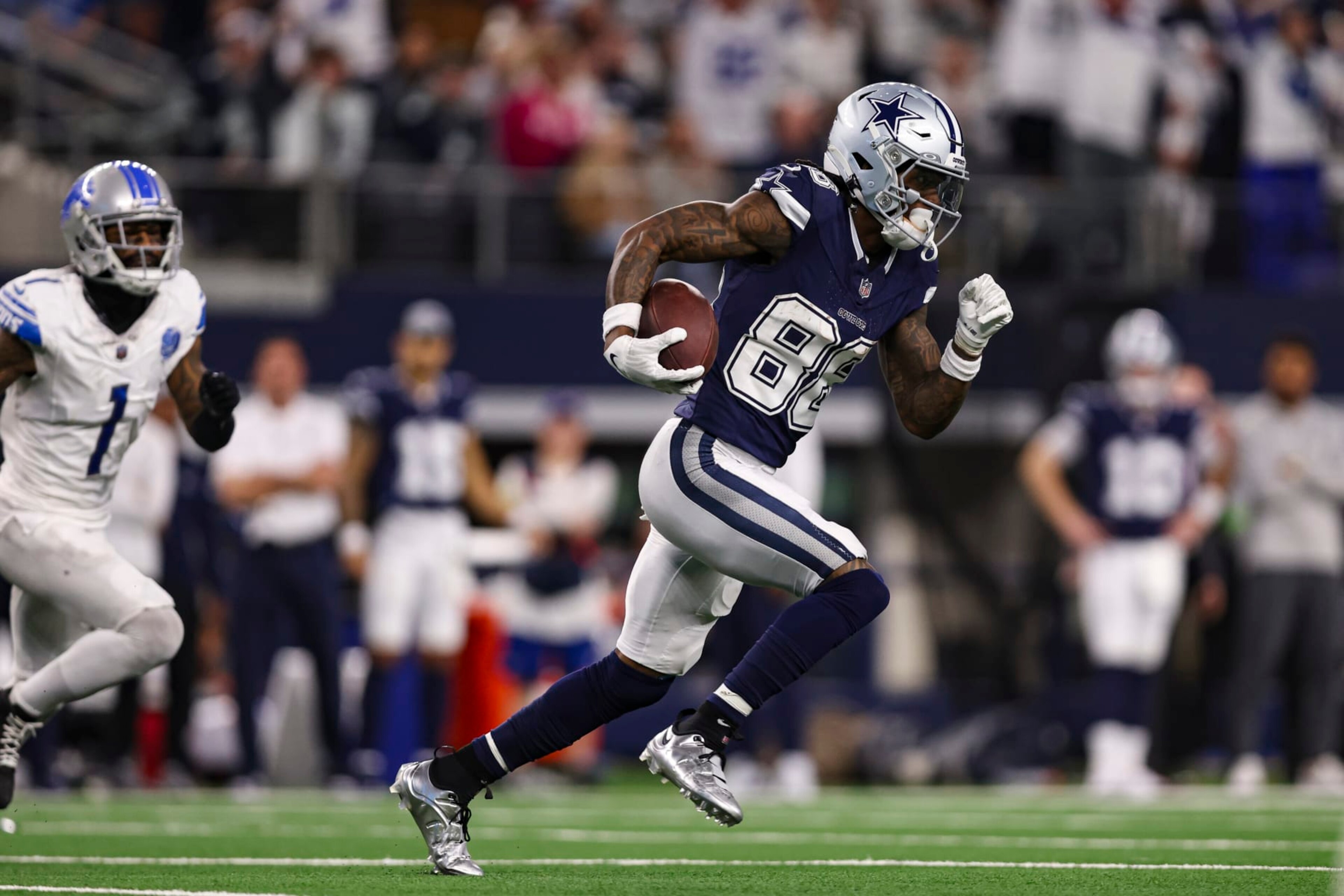 ARLINGTON, TX - DECEMBER 30: CeeDee Lamb #88 of the Dallas Cowboys runs with the ball during an NFL football game against the Detroit Lions at AT&T Stadium on December 30, 2023 in Arlington, Texas. (Photo by Perry Knotts/Getty Images)