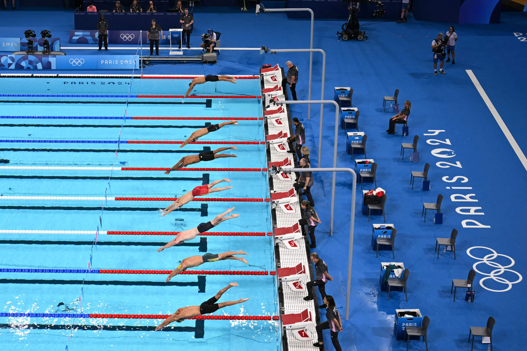 Swimmers dive as they take the start of a heat 3  of the men's 200m individual medley swimming event during the Paris 2024 Olympic Games at the Paris La Defense Arena in Nanterre, west of Paris, on August 1, 2024. (Photo by Jonathan NACKSTRAND / AFP) (Photo by JONATHAN NACKSTRAND/AFP via Getty Images)