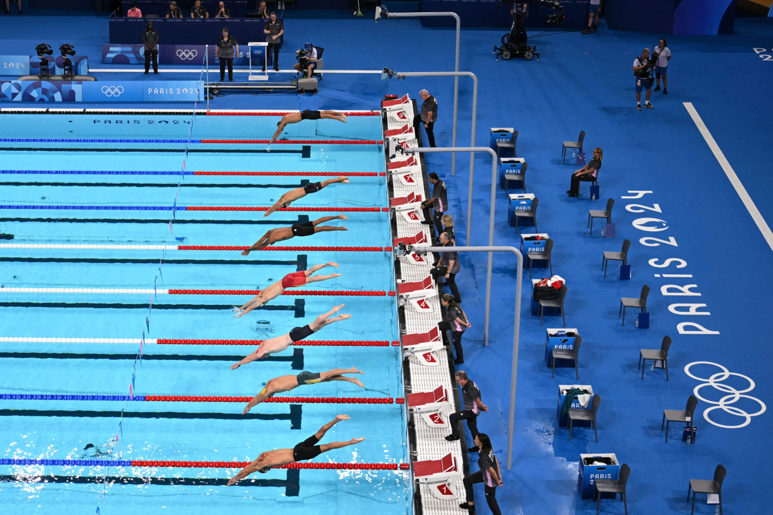 Swimmers dive as they take the start of a heat 3 of the men's 200m individual medley swimming event during the Paris 2024 Olympic Games at the Paris La Defense Arena in Nanterre, west of Paris, on August 1, 2024. (Photo by Jonathan NACKSTRAND / AFP) (Photo by JONATHAN NACKSTRAND/AFP via Getty Images) Swimmers dive as they take the start of a heat 3 of the men's 200m individual medley swimming event during the Paris 2024 Olympic Games at the Paris La Defense Arena in Nanterre, west of Paris, on August 1, 2024. (Photo by Jonathan NACKSTRAND / AFP) (Photo by JONATHAN NACKSTRAND/AFP via Getty Images)