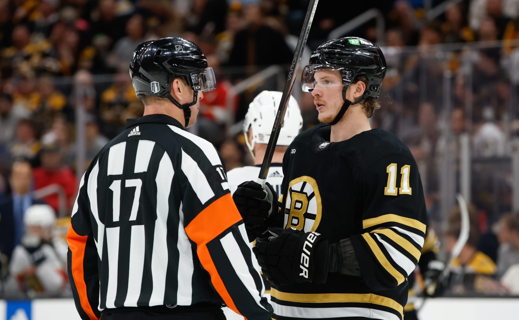 BOSTON, MASSACHUSETTS - MAY 12: Trent Frederic #11 of the Boston Bruins talks to referee Frederick L'Ecuyer #17 in Game Four of the Second Round of the 2024 Stanley Cup Playoffs at the TD Garden on May 12, 2024 in Boston, Massachusetts. The Panthers won 3-2. (Photo by Rich Gagnon/Getty Images)