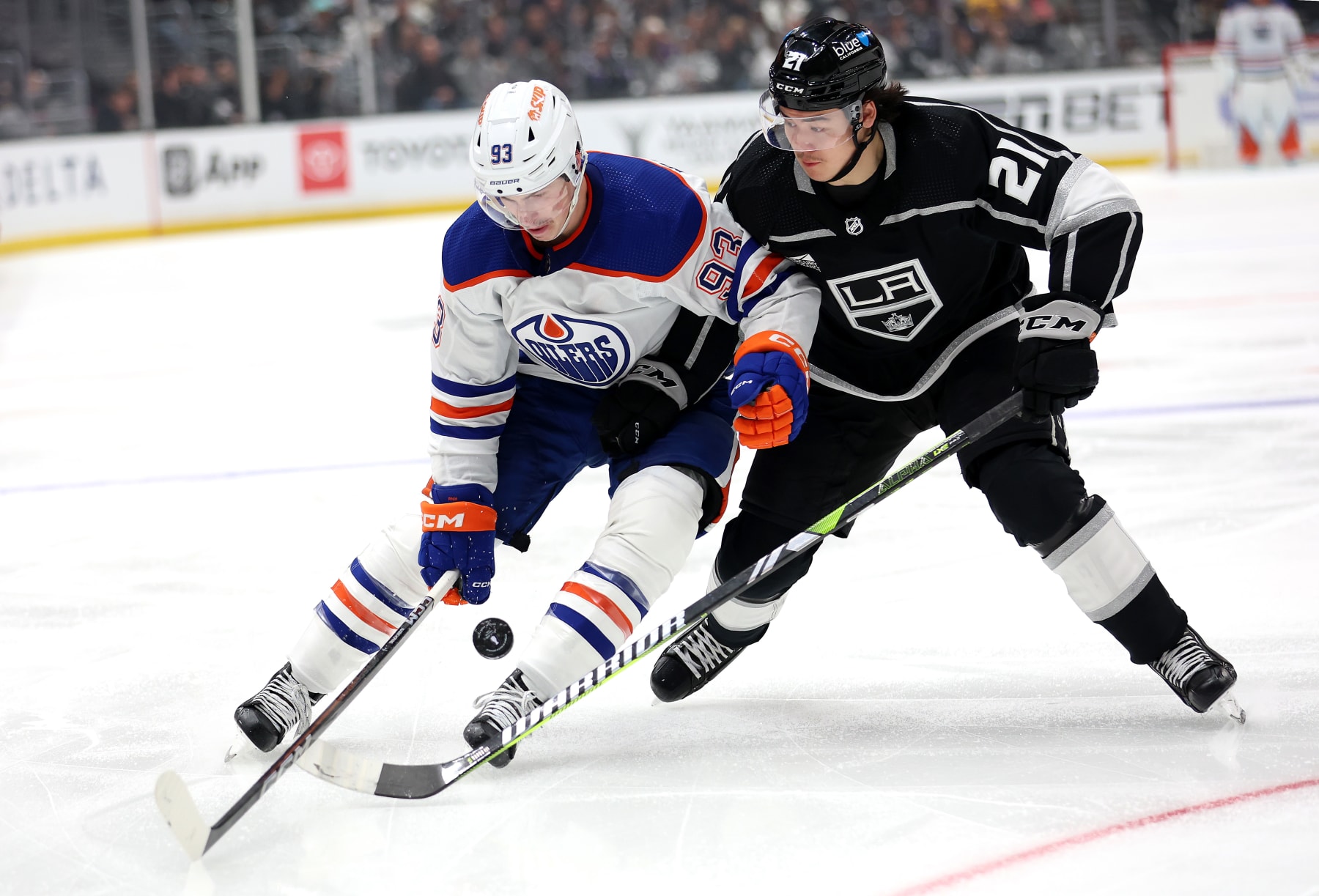 LOS ANGELES, CALIFORNIA - APRIL 26: Ryan Nugent-Hopkins #93 of the Edmonton Oilers battles Jordan Spence #21 of the Los Angeles Kings for a loose puck during the third period of Game Three of the First Round of the 2024 Stanley Cup Playoffs at Crypto.com Arena on April 26, 2024 in Los Angeles, California.  (Photo by Sean M. Haffey/Getty Images)