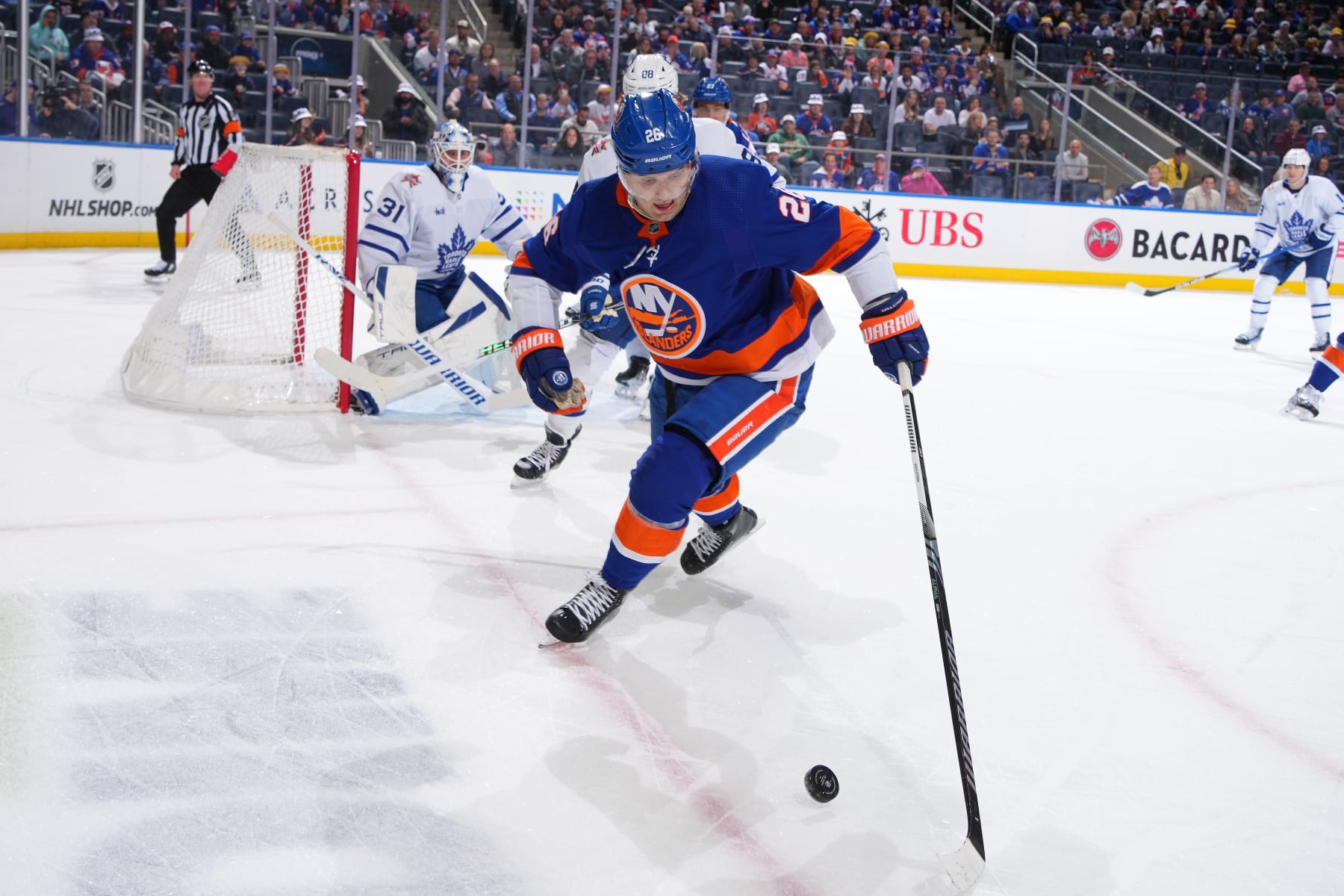 ELMONT, NEW YORK - JANUARY 11:  Oliver Wahlstrom #26 of the New York Islanders handles the puck against the Toronto Maple Leafs during the first period at UBS Arena on January 11, 2024 in Elmont, New York. (Photo by Mike Stobe/NHLI via Getty Images)