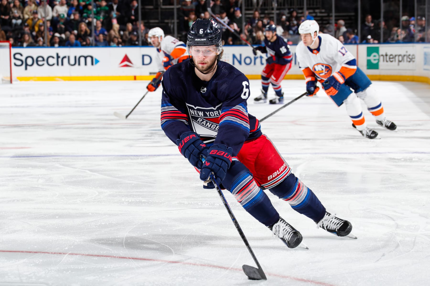 NEW YORK, NEW YORK - MARCH 17:  Zac Jones #6 of the New York Rangers skates with the puck against the New York Islanders at Madison Square Garden on March 17, 2024 in New York City. (Photo by Jared Silber/NHLI via Getty Images)
