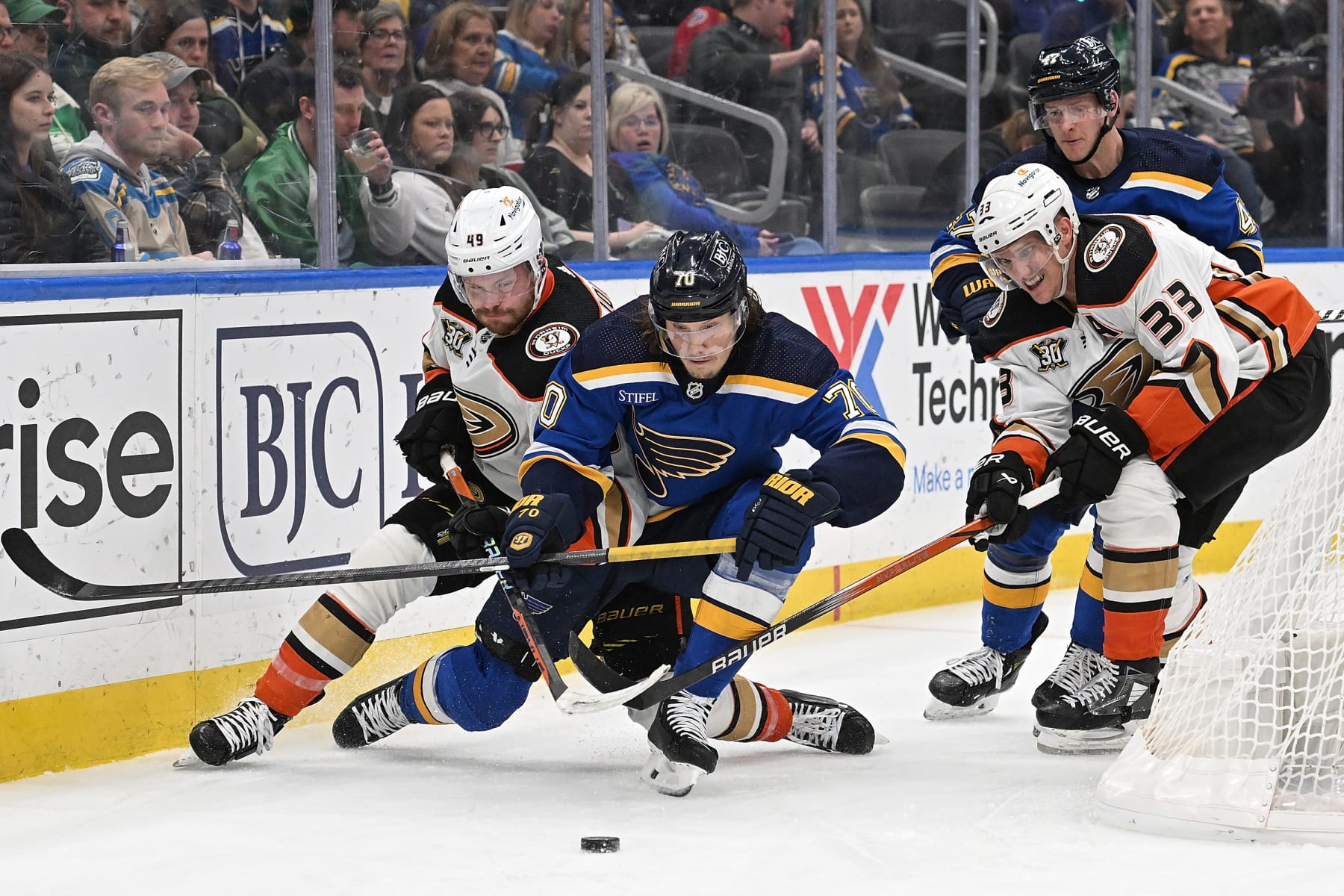 ST. LOUIS, MO - MARCH 17: Max Jones #49 Jakob Silfverberg #33 of the Anaheim Ducks and Oskar Sundqvist #70 of the St. Louis Blues battle for the puck on March 17, 2024 at the Enterprise Center in St. Louis, Missouri. (Photo by Joe Puetz/NHLI via Getty Images)