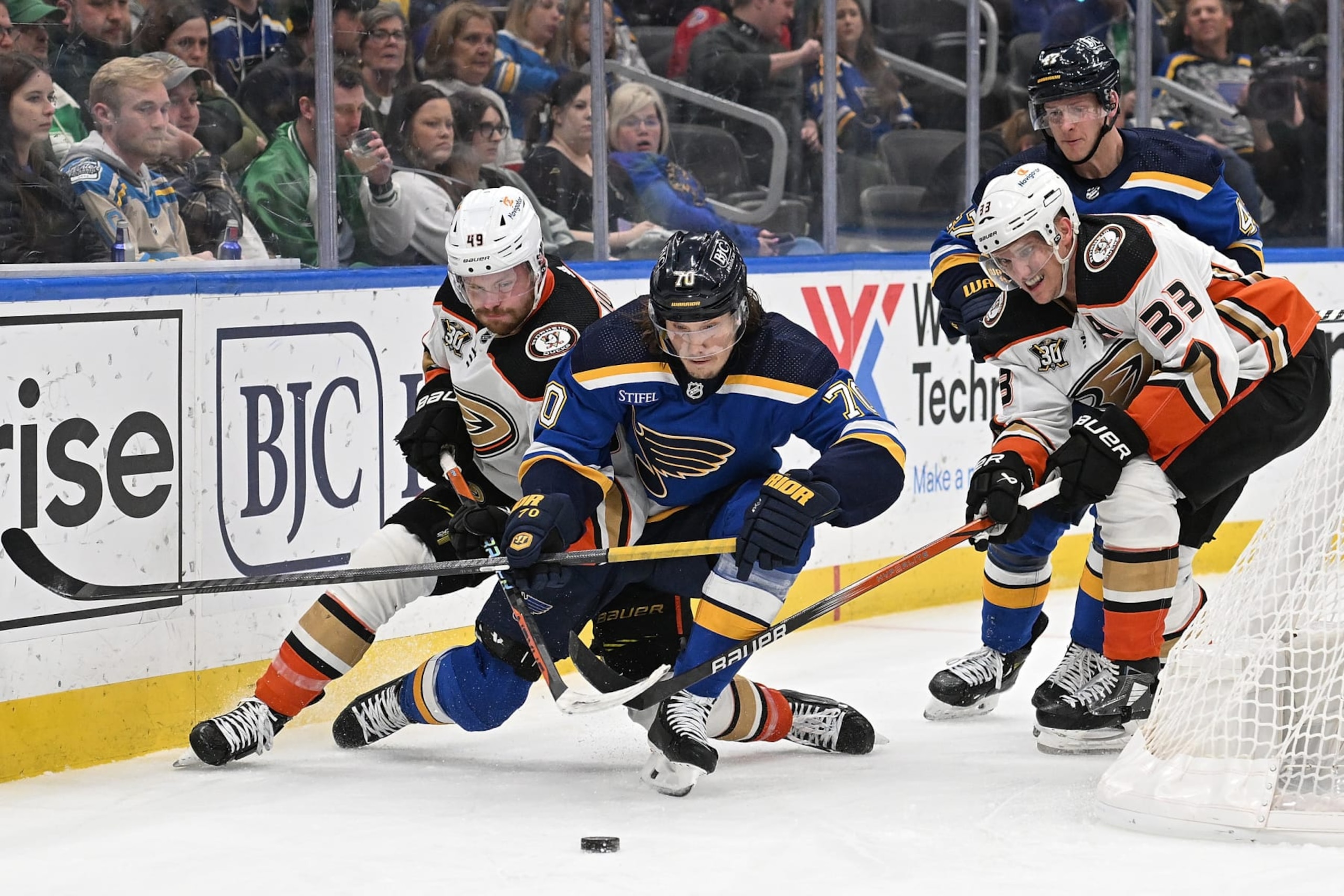 ST. LOUIS, MO - MARCH 17: Max Jones #49 Jakob Silfverberg #33 of the Anaheim Ducks and Oskar Sundqvist #70 of the St. Louis Blues battle for the puck on March 17, 2024 at the Enterprise Center in St. Louis, Missouri. (Photo by Joe Puetz/NHLI via Getty Images)