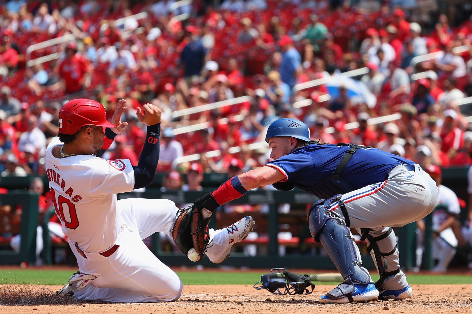 ST LOUIS, MISSOURI - JULY 31: Willson Contreras #40 of the St. Louis Cardinals scores a run against Carson Kelly #18 of the Texas Rangers in the fifth inning at Busch Stadium on July 31, 2024 in St Louis, Missouri. (Photo by Dilip Vishwanat/Getty Images)