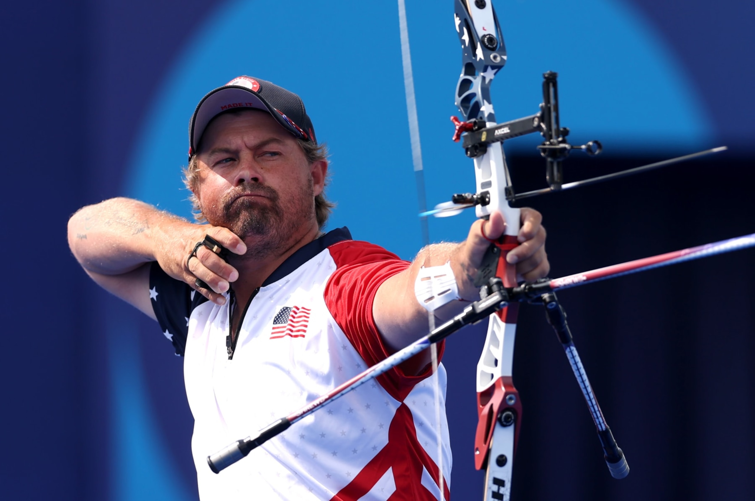 PARIS, FRANCE - AUGUST 02: Brady Ellison of Team United States competes during the Mixed Team 1/8 Elimination Round match between Team United States and Team Uzbekistan on day seven of the Olympic Games Paris 2024 at Esplanade Des Invalides on August 02, 2024 in Paris, France. (Photo by Alex Pantling/Getty Images)