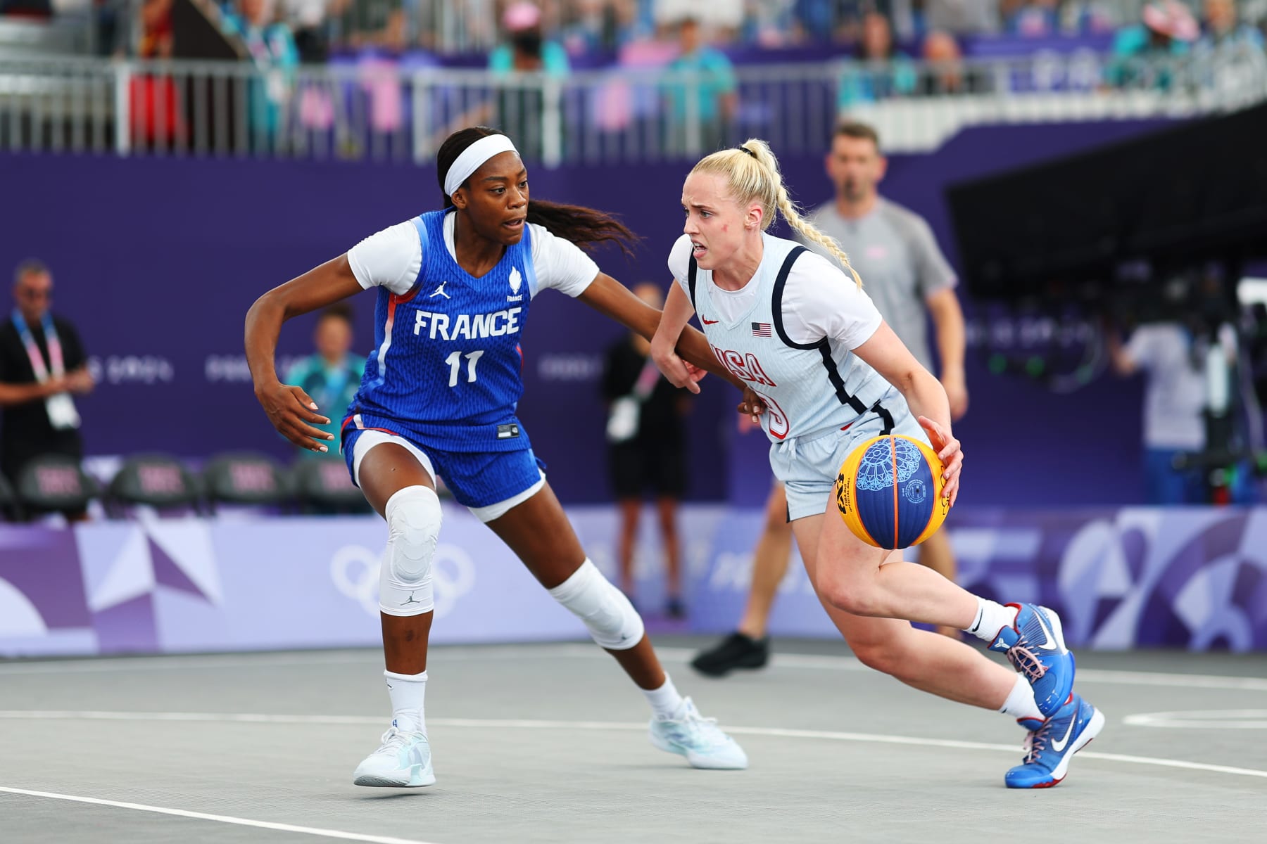 PARIS, FRANCE - AUGUST 02: Hailey van Lith #9 of Team United States dribbles the ball against Myriam Djekoundade #11 of Team France during the Women's 3x3 Basketball Pool Round match between Team Australia and Team Spain on day seven of the Olympic Games Paris 2024 at Esplanade Des Invalides on August 02, 2024 in Paris, France. (Photo by Lintao Zhang/Getty Images)