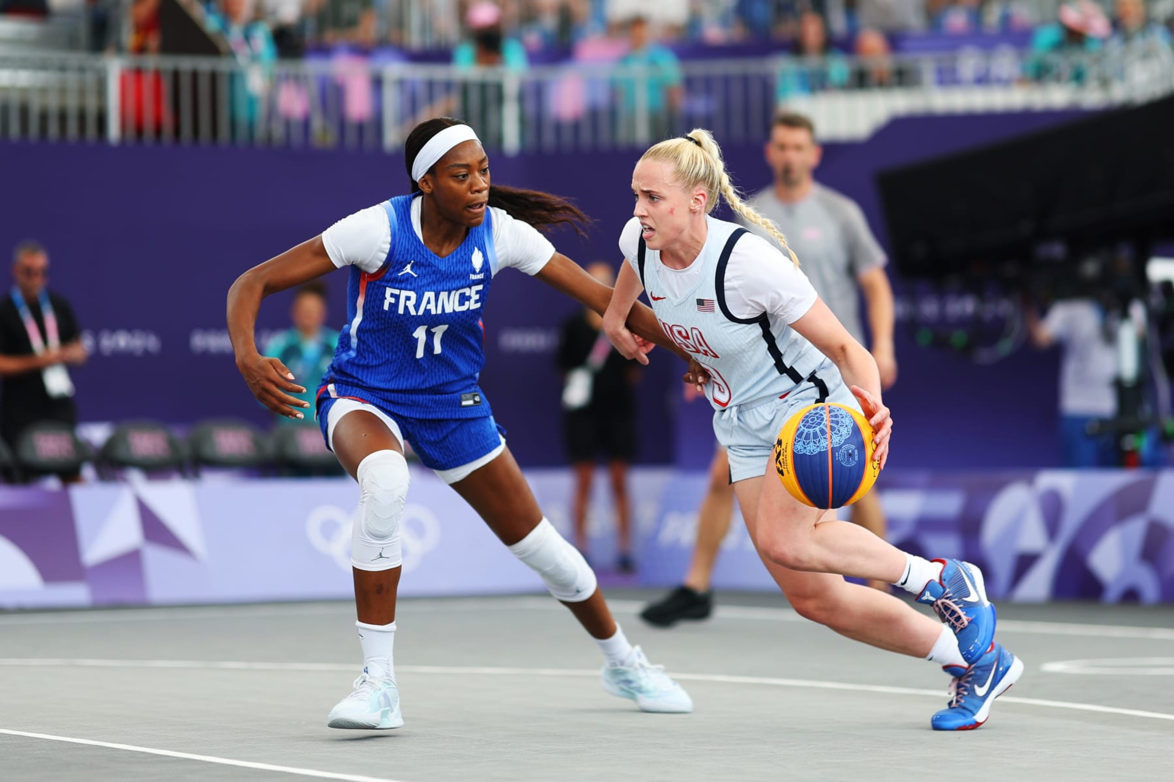 PARIS, FRANCE - AUGUST 02: Hailey van Lith #9 of Team United States dribbles the ball against Myriam Djekoundade #11 of Team France during the Women's 3x3 Basketball Pool Round match between Team Australia and Team Spain on day seven of the Olympic Games Paris 2024 at Esplanade Des Invalides on August 02, 2024 in Paris, France. (Photo by Lintao Zhang/Getty Images)
