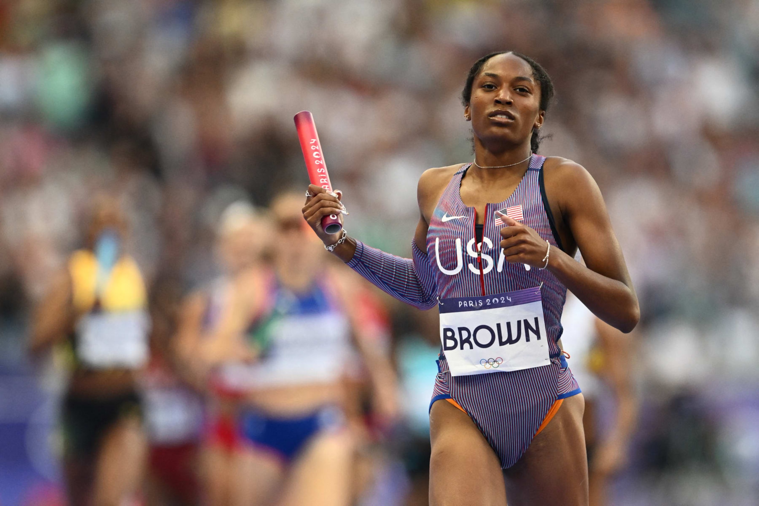 US' Kaylyn Brown runs with the baton in the mixed 4x400m relay heat of the athletics event at the Paris 2024 Olympic Games at Stade de France in Saint-Denis, north of Paris, on August 2, 2024. (Photo by Jewel SAMAD / AFP) (Photo by JEWEL SAMAD/AFP via Getty Images)