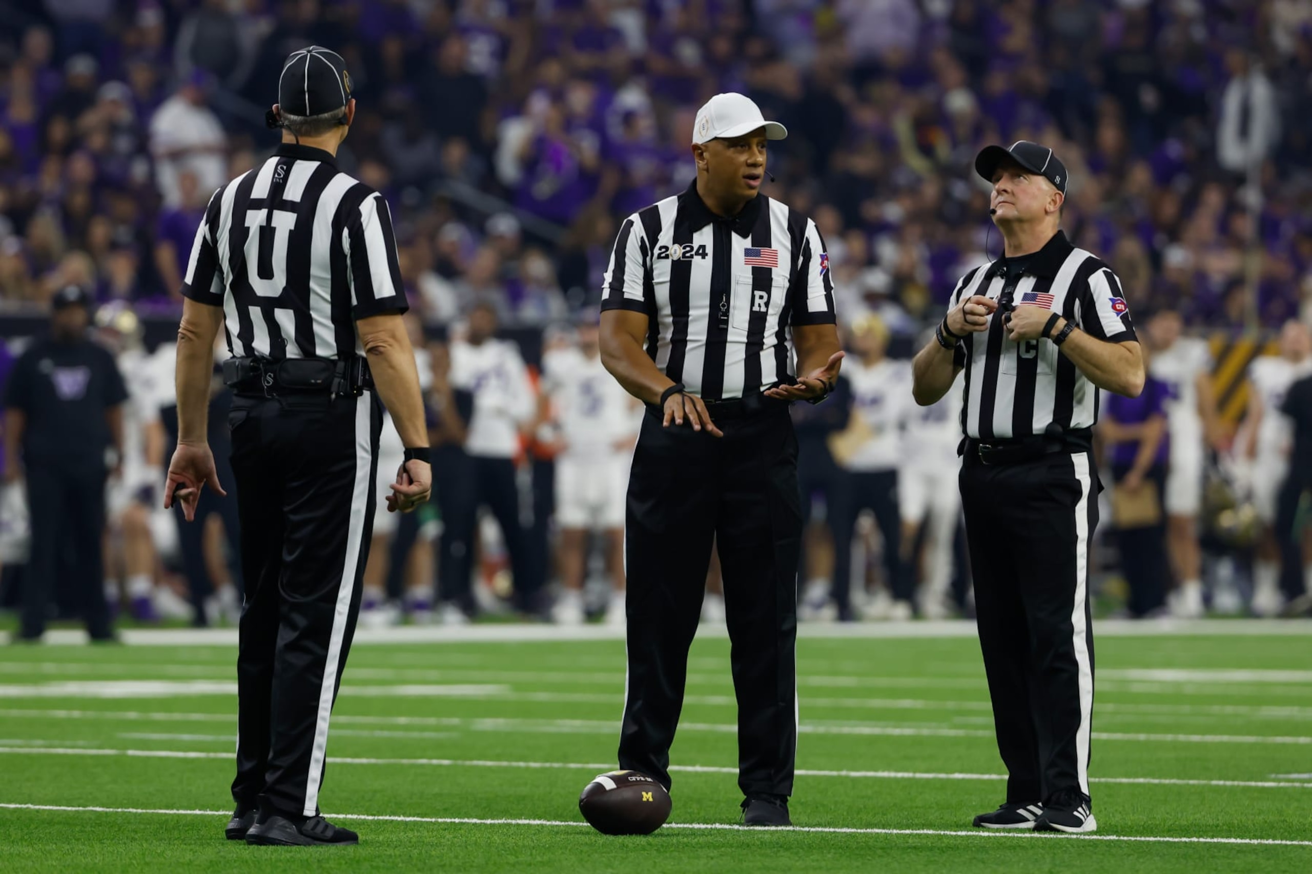 HOUSTON, TX - JANUARY 08: The referees stand around the ball during a timeout of the CFP National Championship game Michigan Wolverines and Washington Huskies on January 8, 2024, at NRG Stadium in Houston, Texas. (Photo by David Buono/Icon Sportswire via Getty Images)