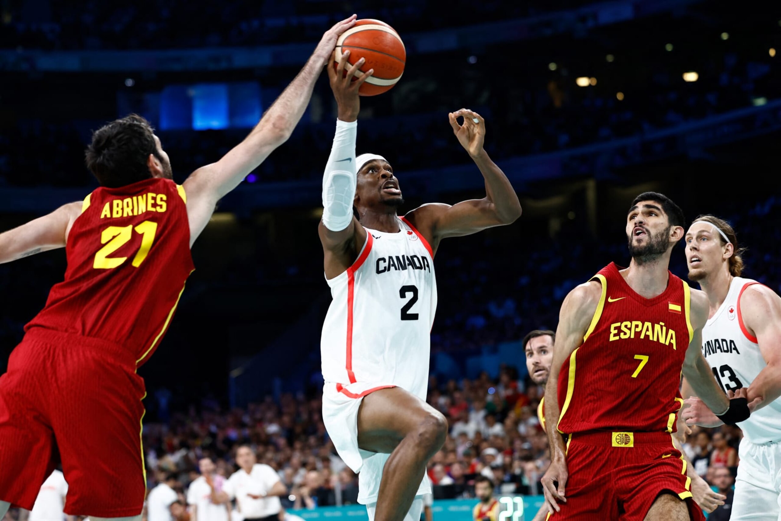 Canada's #02 Shai Gilgeous-Alexander goes to the basket past Spain's #21 Alex Abrines (L) and Spain's #07 Santi Aldama in the men's preliminary round group A basketball match between Canada and Spain during the Paris 2024 Olympic Games at the Pierre-Mauroy stadium in Villeneuve-d'Ascq, northern France, on August 2, 2024. (Photo by Sameer Al-Doumy / AFP) (Photo by SAMEER AL-DOUMY/AFP via Getty Images)