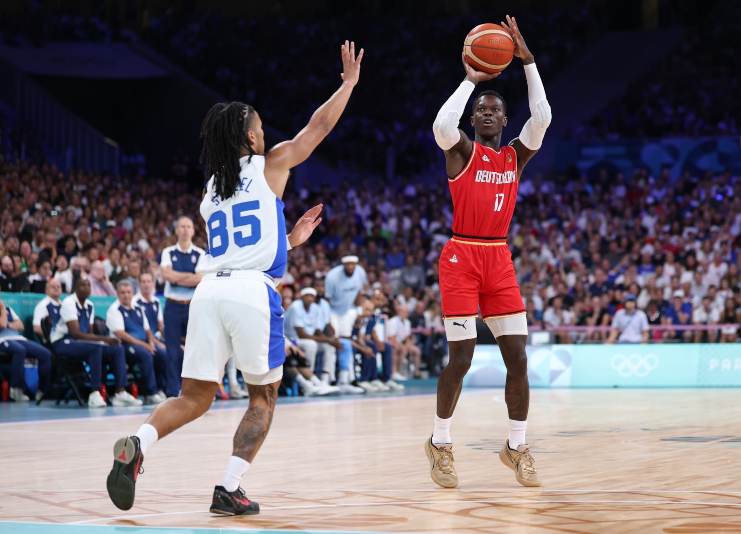 LILLE, FRANCE - AUGUST 02: Dennis Schroder #17 of Team Germany shoots over Matthew Strazel #85 of Team France during the Men's Group Phase - Group B game between Team France and Team Germany on day seven of the Olympic Games Paris 2024 at Stade Pierre Mauroy on August 02, 2024 in Lille, France. (Photo by Gregory Shamus/Getty Images)