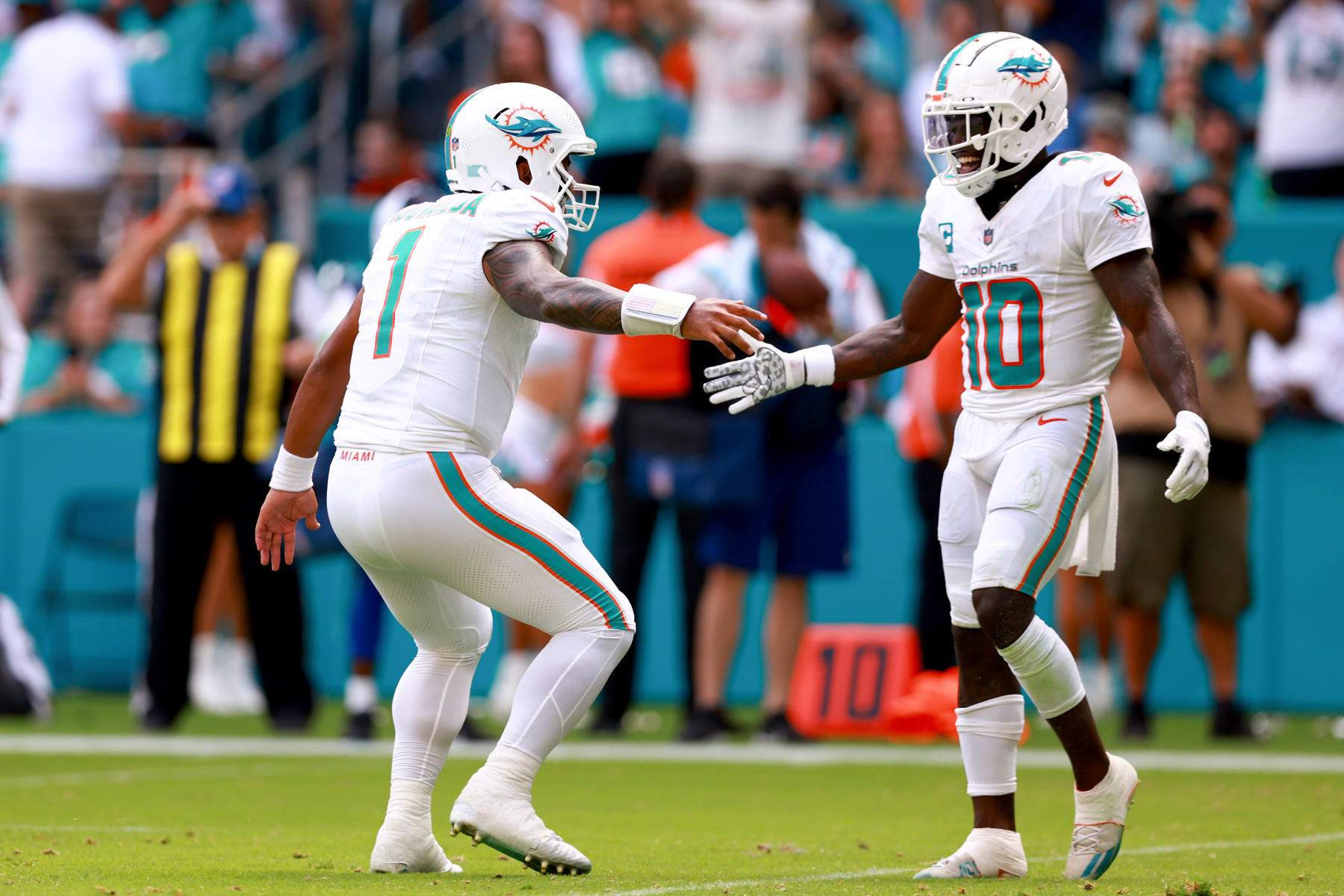 MIAMI GARDENS, FLORIDA - SEPTEMBER 24: Tua Tagovailoa #1 of the Miami Dolphins and Tyreek Hill #10 of the Miami Dolphins celebrate after a Miami touchdown during the third quarter against the Denver Broncos at Hard Rock Stadium on September 24, 2023 in Miami Gardens, Florida. (Photo by Megan Briggs/Getty Images)