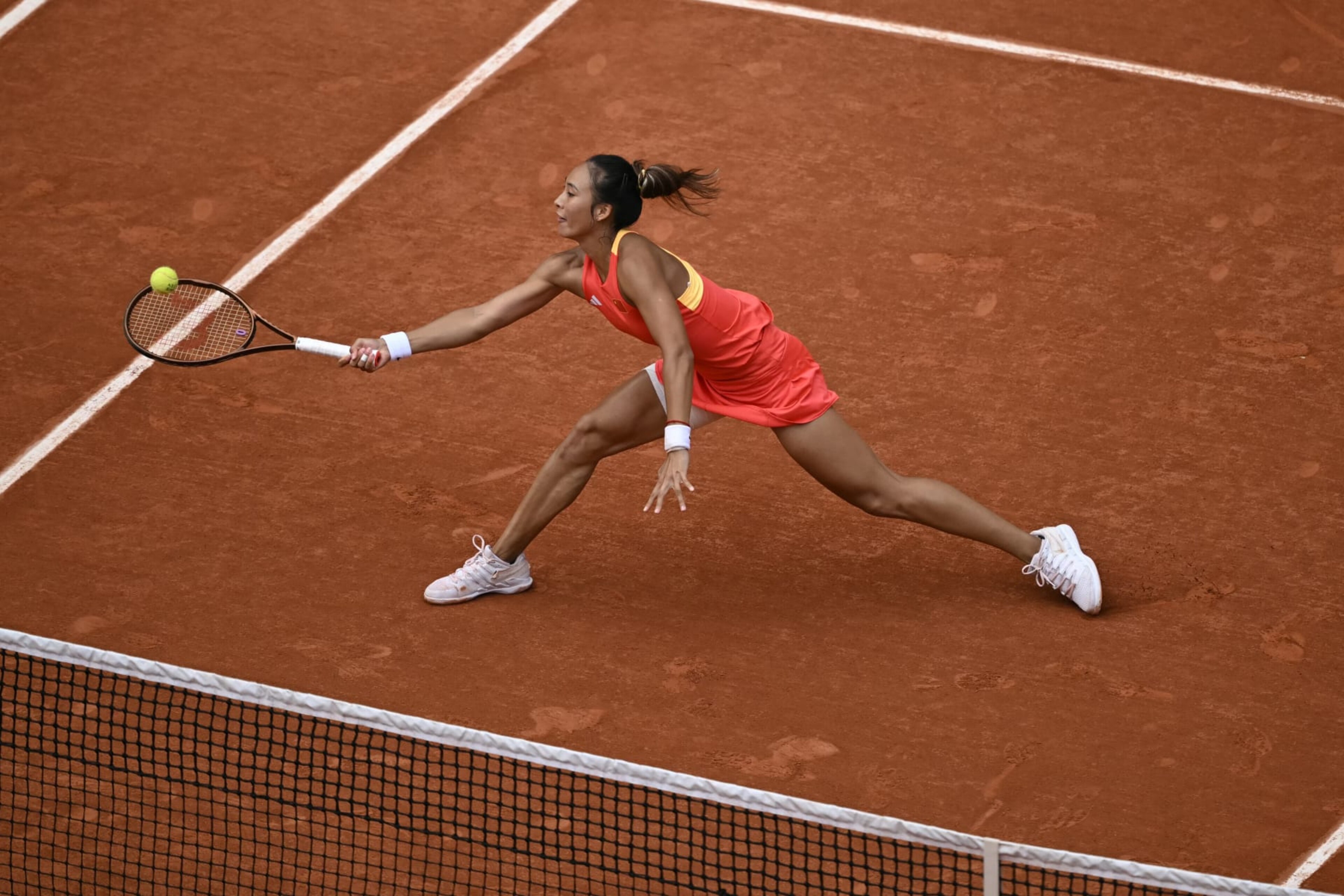 China's Zheng Qinwen returns to Croatia's Donna Vekic during their women's singles final tennis match on Court Philippe-Chatrier at the Roland-Garros Stadium during the Paris 2024 Olympic Games, in Paris on August 3, 2024. (Photo by CARL DE SOUZA / AFP) (Photo by CARL DE SOUZA/AFP via Getty Images)