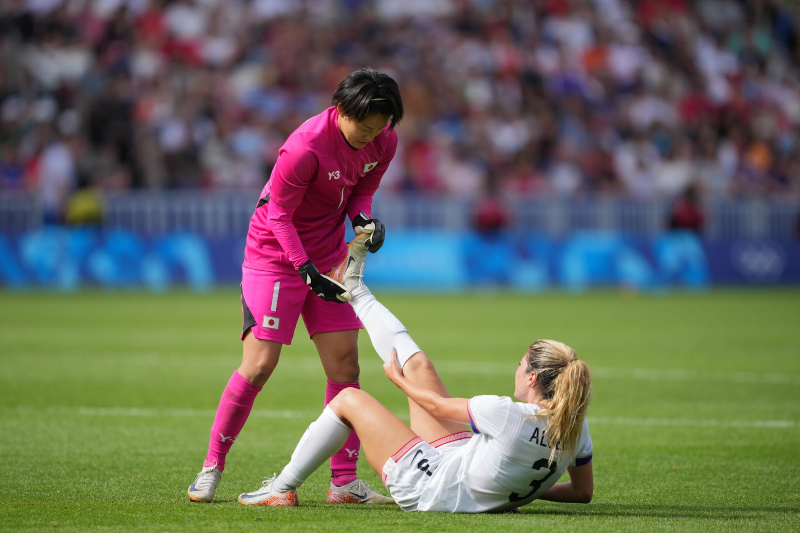 PARIS, FRANCE - AUGUST 03: Ayaka Yamashita #1 of Japan helps Korbin Albert #3 of the United States during extra time of the Women's Quarterfinal match during the Olympic Games Paris 2024 at Parc des Princes on August 03, 2024 in Paris, France. (Photo by John Todd/ISI/Getty Images)