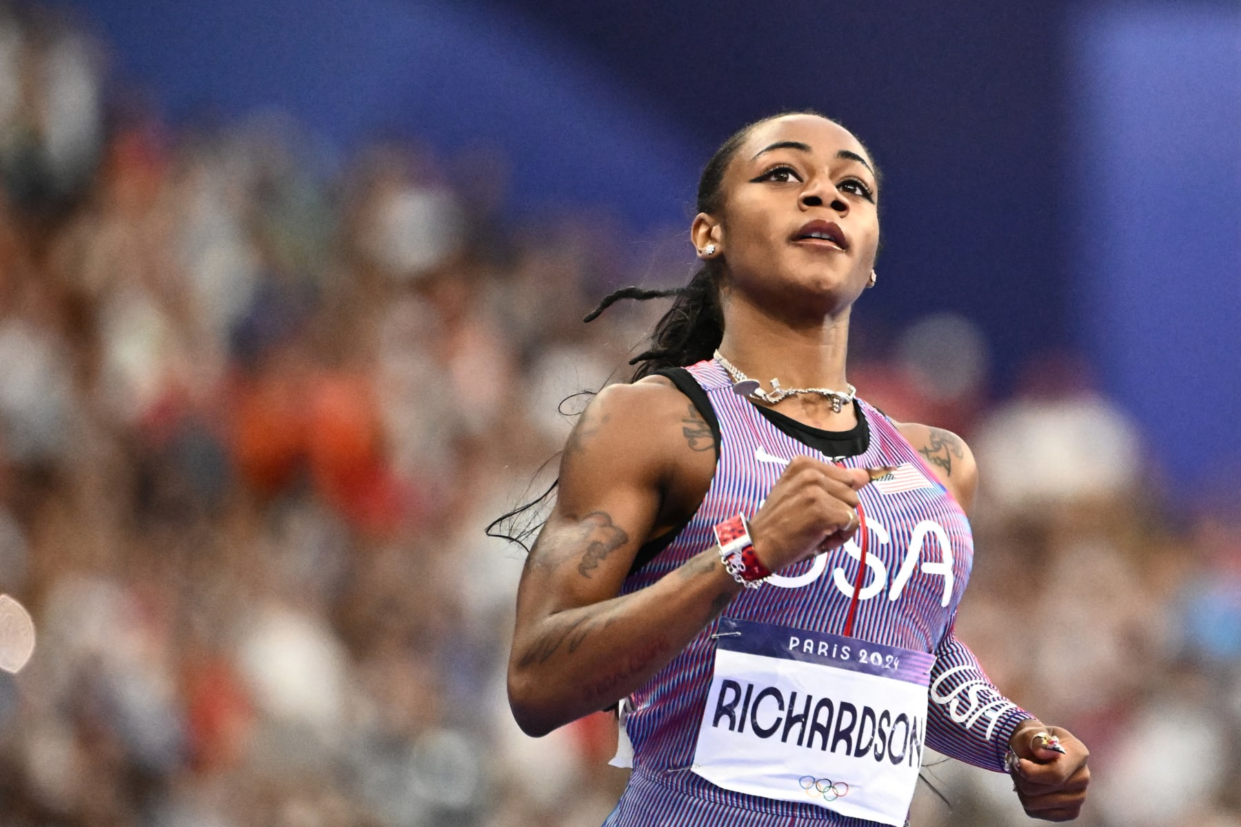 US' Sha'Carri Richardson reacts after competing in the women's 100m semi-final of the athletics event at the Paris 2024 Olympic Games at Stade de France in Saint-Denis, north of Paris, on August 3, 2024. (Photo by Jewel SAMAD / AFP) (Photo by JEWEL SAMAD/AFP via Getty Images)