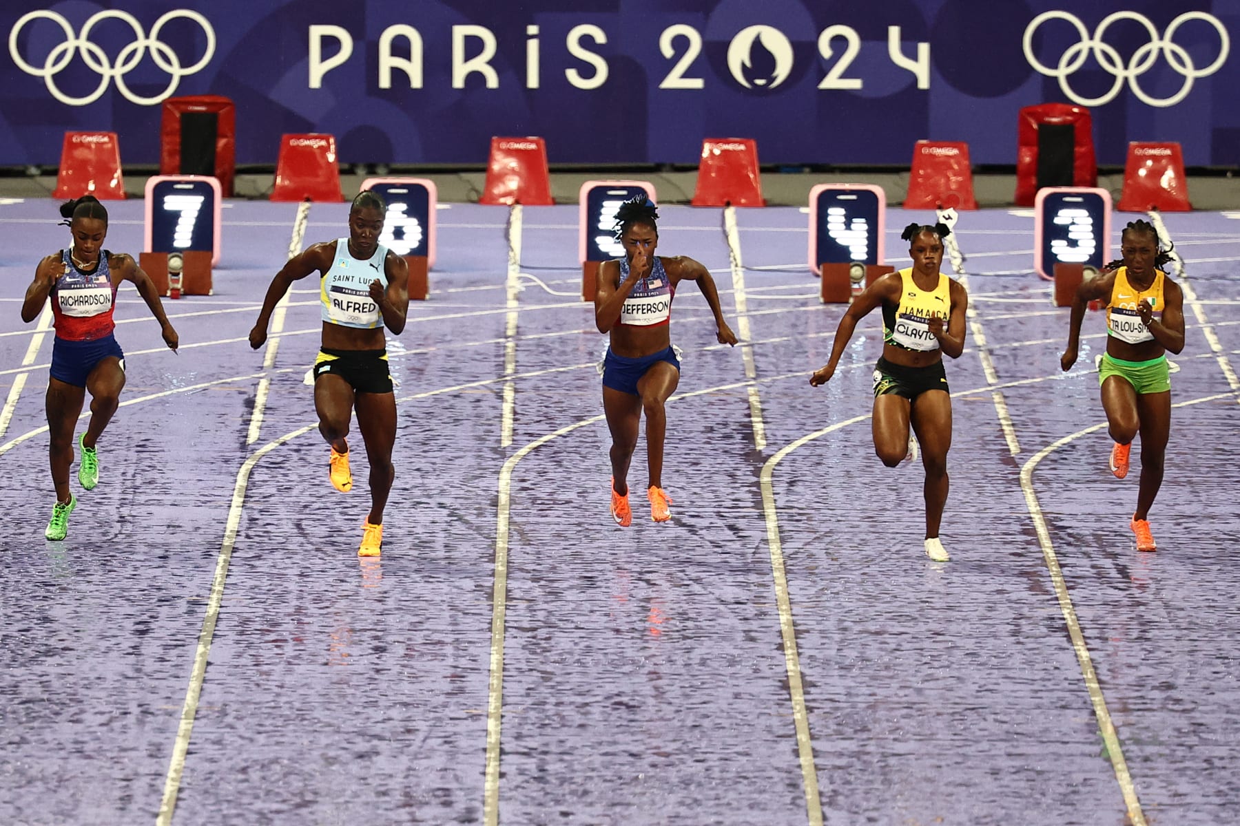 US' Sha'Carri Richardson, St Lucia's Julien Alfred, US' Melissa Jefferson, Jamaica's Tia Clayton and Ivory Coast's Marie Josee Ta Lou-Smith competes in the women's 100m final of the athletics event at the Paris 2024 Olympic Games at Stade de France in Saint-Denis, north of Paris, on August 3, 2024. (Photo by Anne-Christine POUJOULAT / AFP) (Photo by ANNE-CHRISTINE POUJOULAT/AFP via Getty Images)