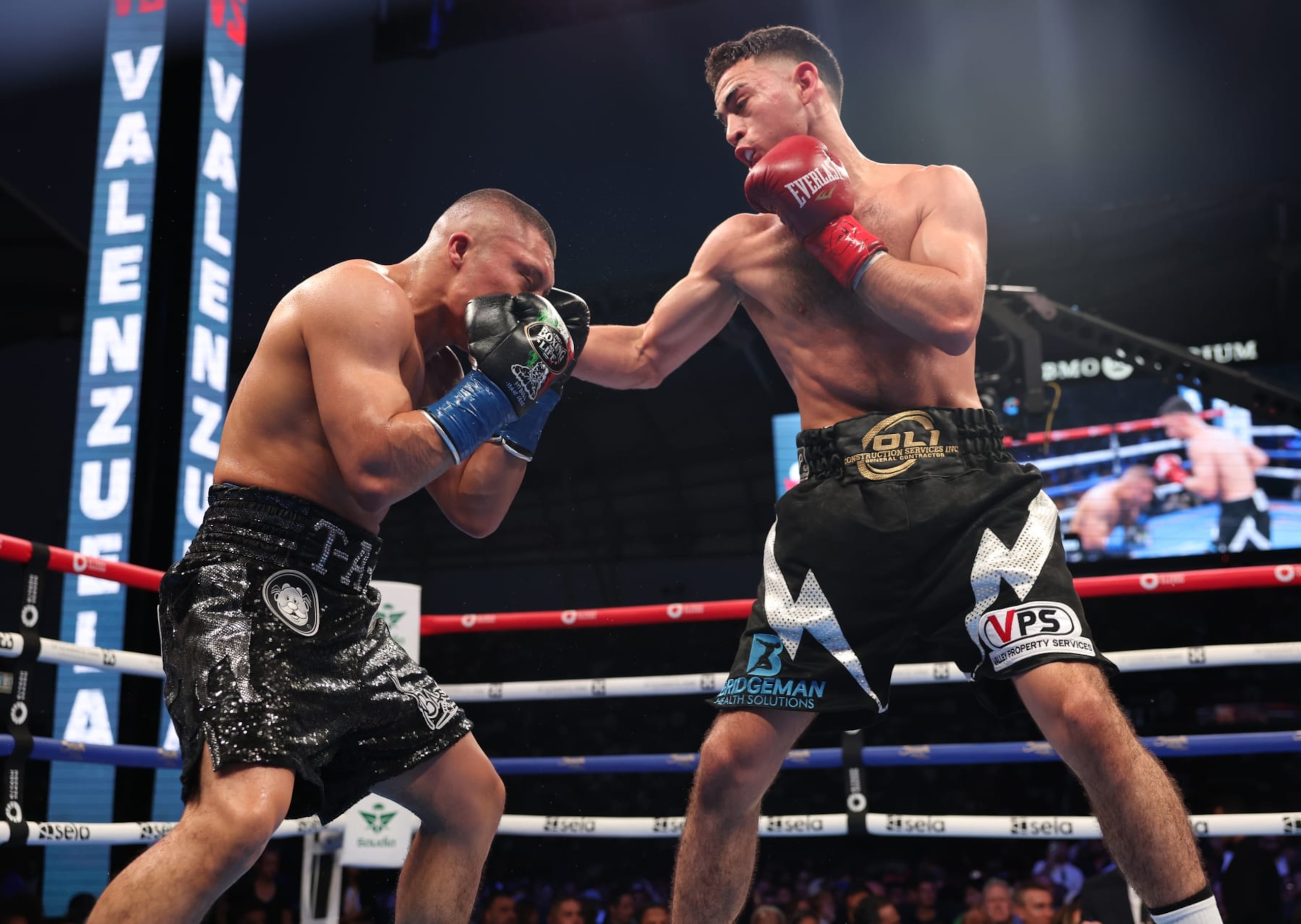 LOS ANGELES, CALIFORNIA - AUGUST 3: Isaac Cruz( black with silver shorts) and Jose Valenzuela (black with white shorts) during their WBA World Super Lightweight Titles Contest at BMO Stadium on August 3, 2024 in Los Angeles, California.  (Photo by Mark Robinson/Matchroom Boxing/Getty Images)