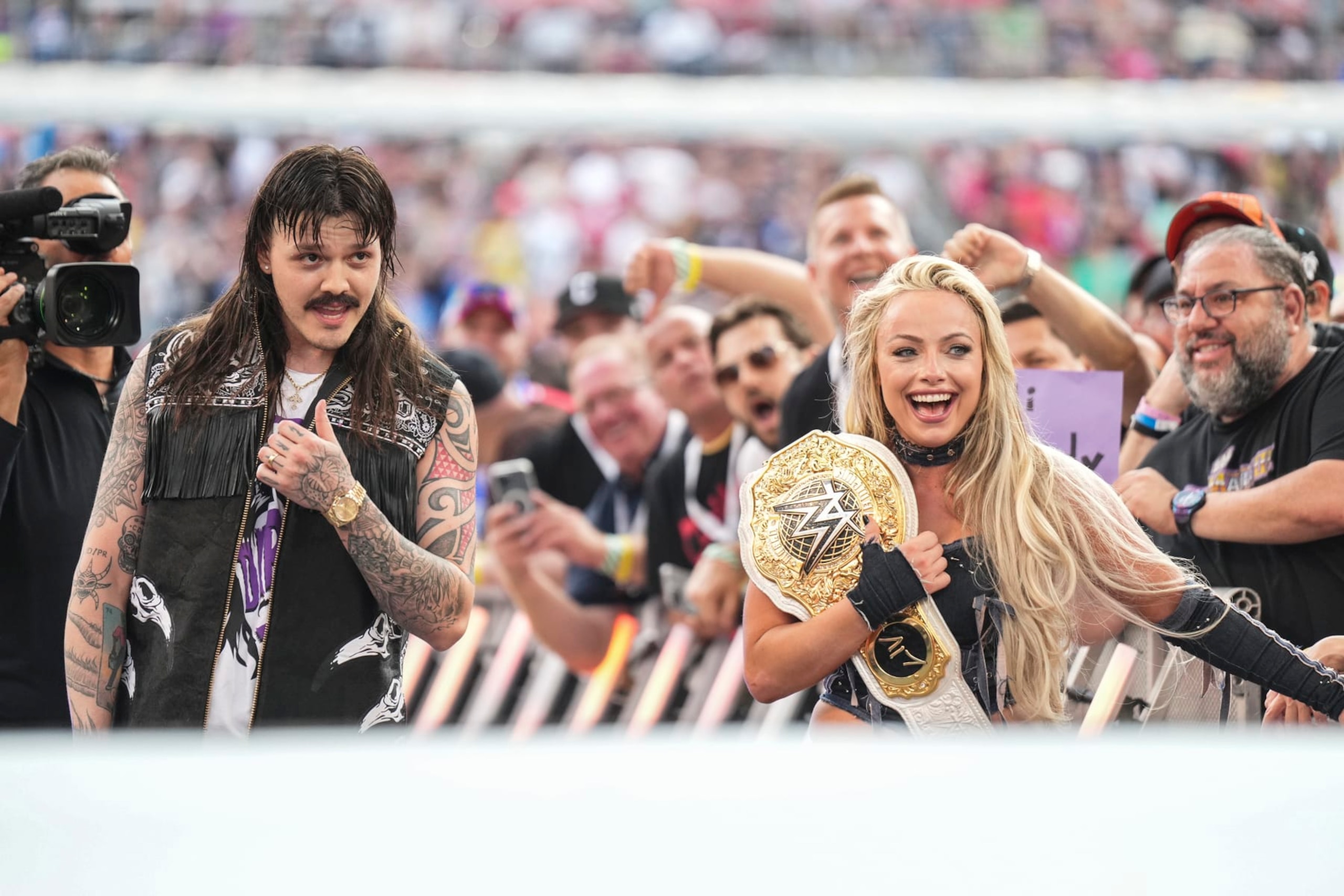 CLEVELAND, OHIO - AUGUST 3: Liv Morgan celebrates her win with Dominik Mysterio during SummerSlam at Cleveland Browns Stadium on August 3, 2024 in Cleveland, Ohio.  (Photo by WWE/Getty Images)