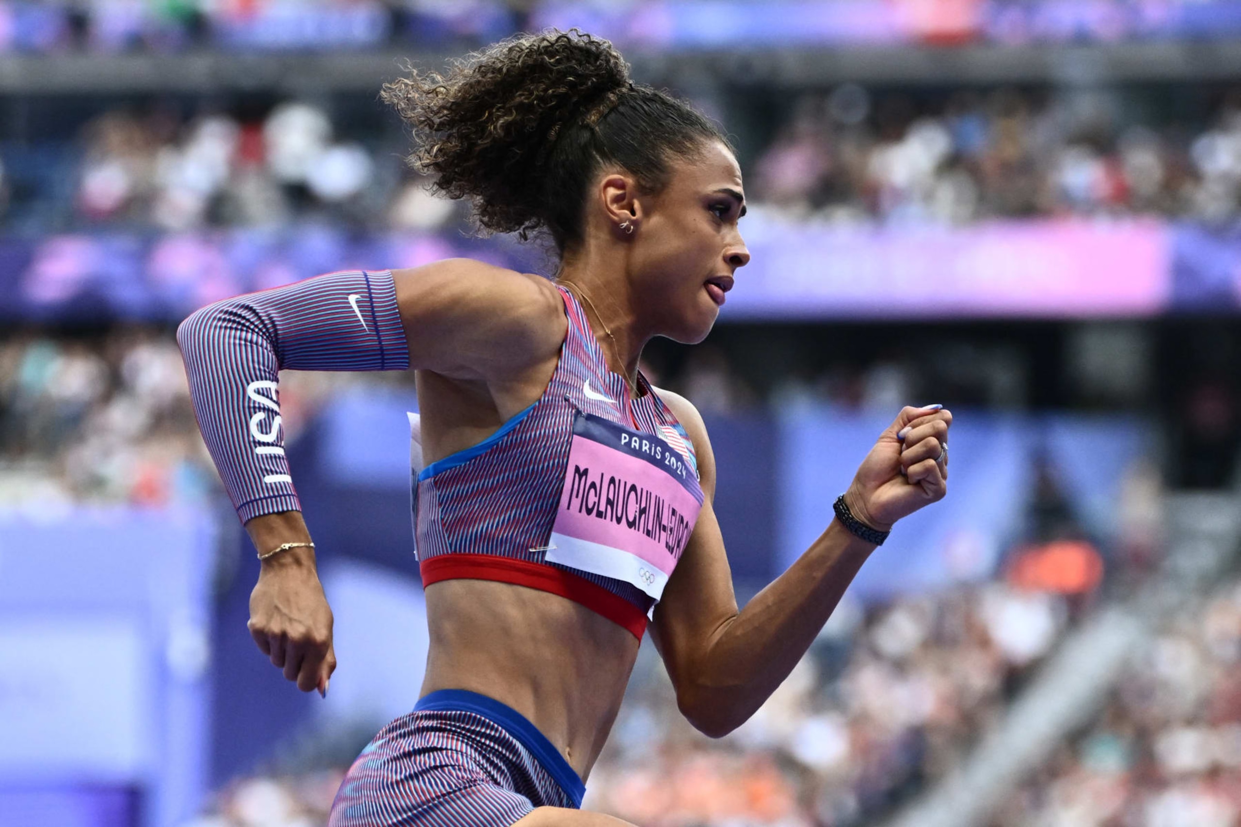 US' Sydney Mclaughlin-Levrone competes in the women's 400m hurdles heat of the athletics event at the Paris 2024 Olympic Games at Stade de France in Saint-Denis, north of Paris, on August 4, 2024. (Photo by Jewel SAMAD / AFP) (Photo by JEWEL SAMAD/AFP via Getty Images)