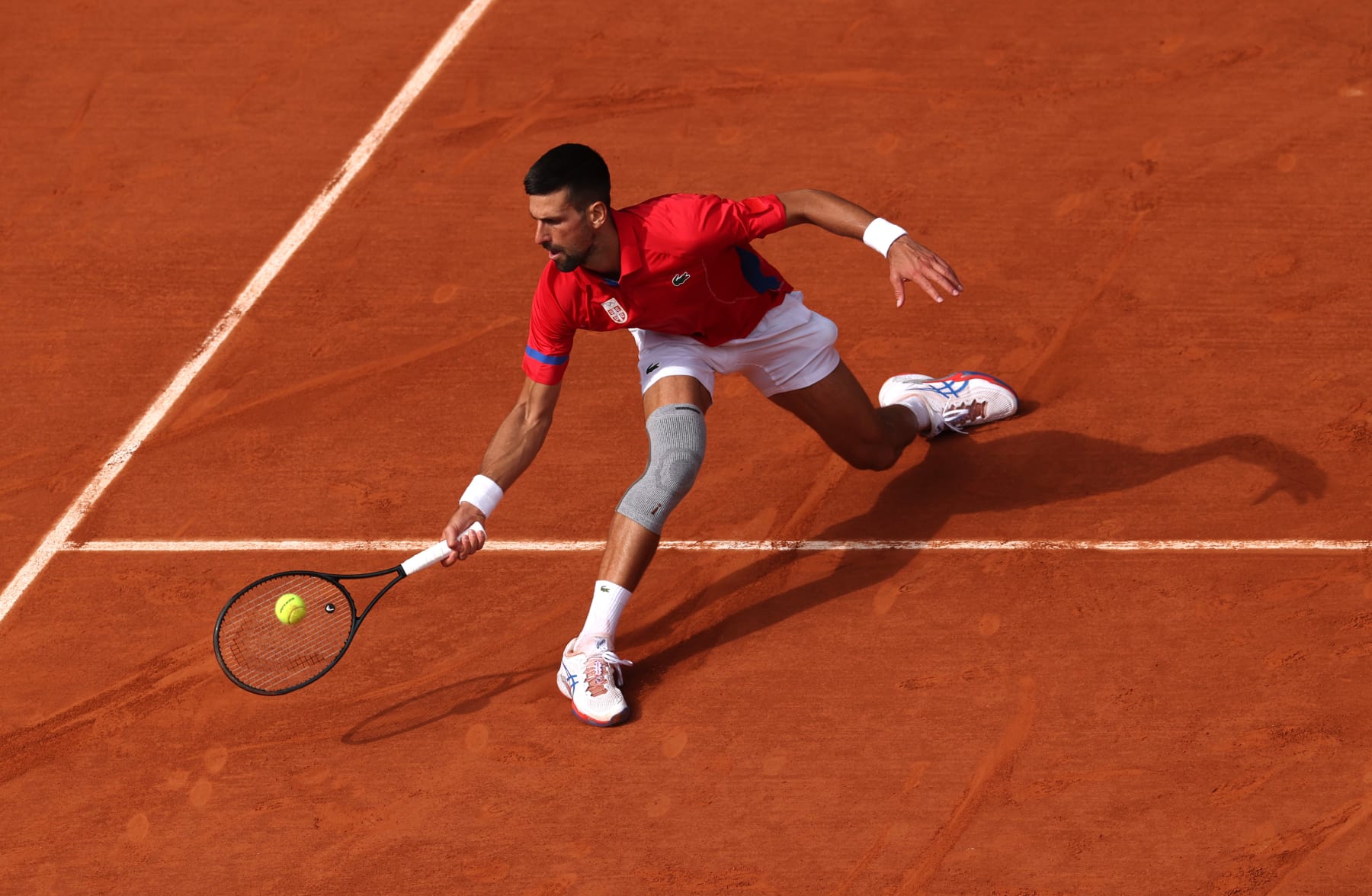 PARIS, FRANCE - AUGUST 04: Novak Djokovic of Team Serbia plays a forehand during the Men's Singles Gold medal match against Carlos Alcaraz of Team Spain on day nine of the Olympic Games Paris 2024 at Roland Garros on August 04, 2024 in Paris, France. (Photo by Matthew Stockman/Getty Images)