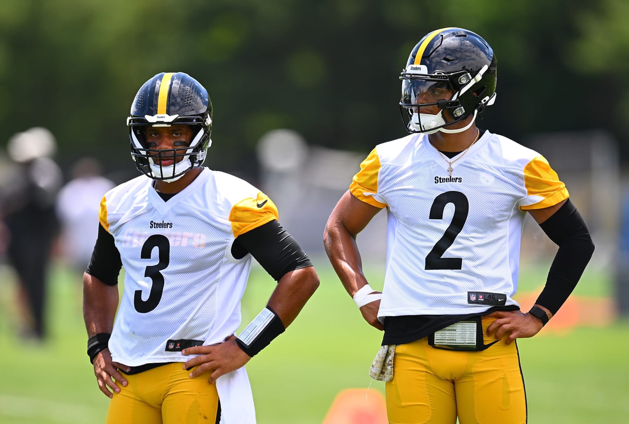 PITTSBURGH, PENNSYLVANIA - JUNE 6: Russell Wilson #3 looks on alongside Justin Fields #2 of the Pittsburgh Steelers during the Pittsburgh Steelers OTA offseason workout at UPMC Rooney Sports Complex on June 6 2024 in Pittsburgh, Pennsylvania. (Photo by Joe Sargent/Getty Images) PITTSBURGH, PENNSYLVANIA - JUNE 6: Russell Wilson #3 looks on alongside Justin Fields #2 of the Pittsburgh Steelers during the Pittsburgh Steelers OTA offseason workout at UPMC Rooney Sports Complex on June 6 2024 in Pittsburgh, Pennsylvania. (Photo by Joe Sargent/Getty Images)