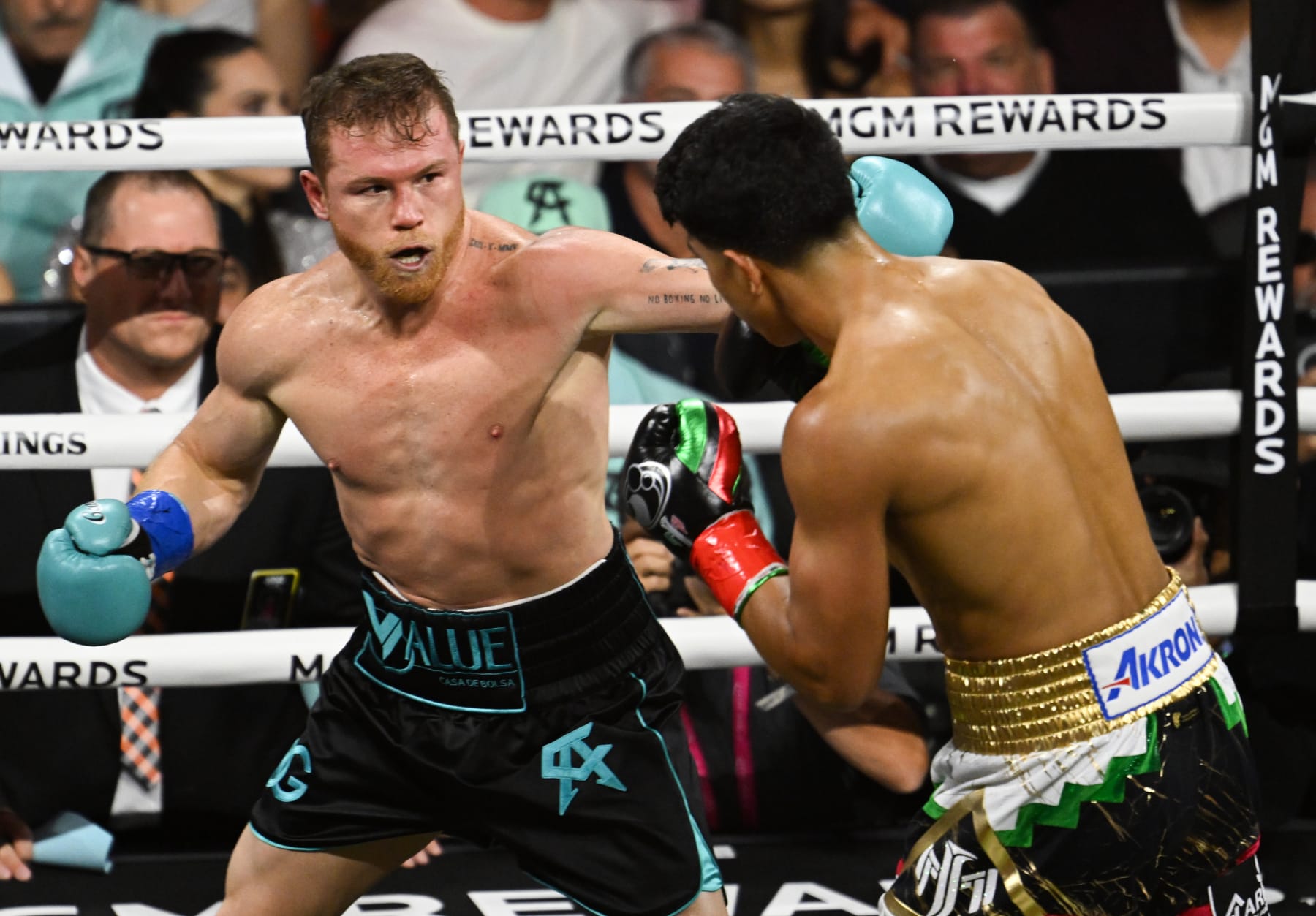 LAS VEGAS, NEVADA - MAY 04: Saul 'Canelo' Alvarez (in black & turquoise short) from Guadalajara, Mexico and Jaime Munguia (in gold & white short) from Tijuana, Mexico exchange punches during their super middleweight undisputed world titles of the Premiere Boxing Championship on Saturday night at the T-Mobile Arena in Las Vegas, Nevada, United States on May 04, 2024. (Photo by Tayfun Coskun/Anadolu via Getty Images)