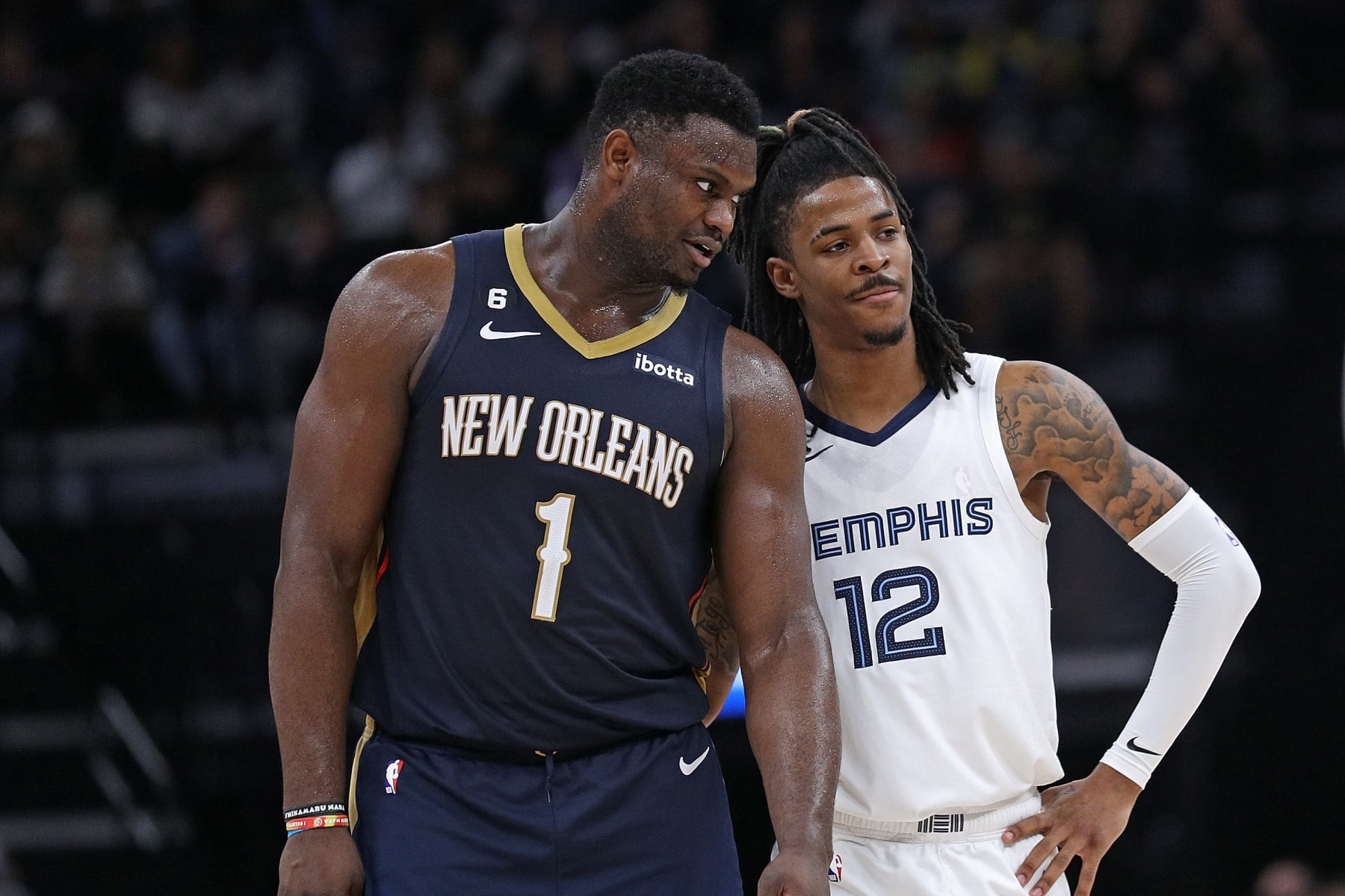 MEMPHIS, TENNESSEE - DECEMBER 31: Zion Williamson #1 of the New Orleans Pelicans and Ja Morant #12 of the Memphis Grizzlies during the game at FedExForum on December 31, 2022 in Memphis, Tennessee. NOTE TO USER: User expressly acknowledges and agrees that, by downloading and or using this photograph, User is consenting to the terms and conditions of the Getty Images License Agreement. (Photo by Justin Ford/Getty Images)