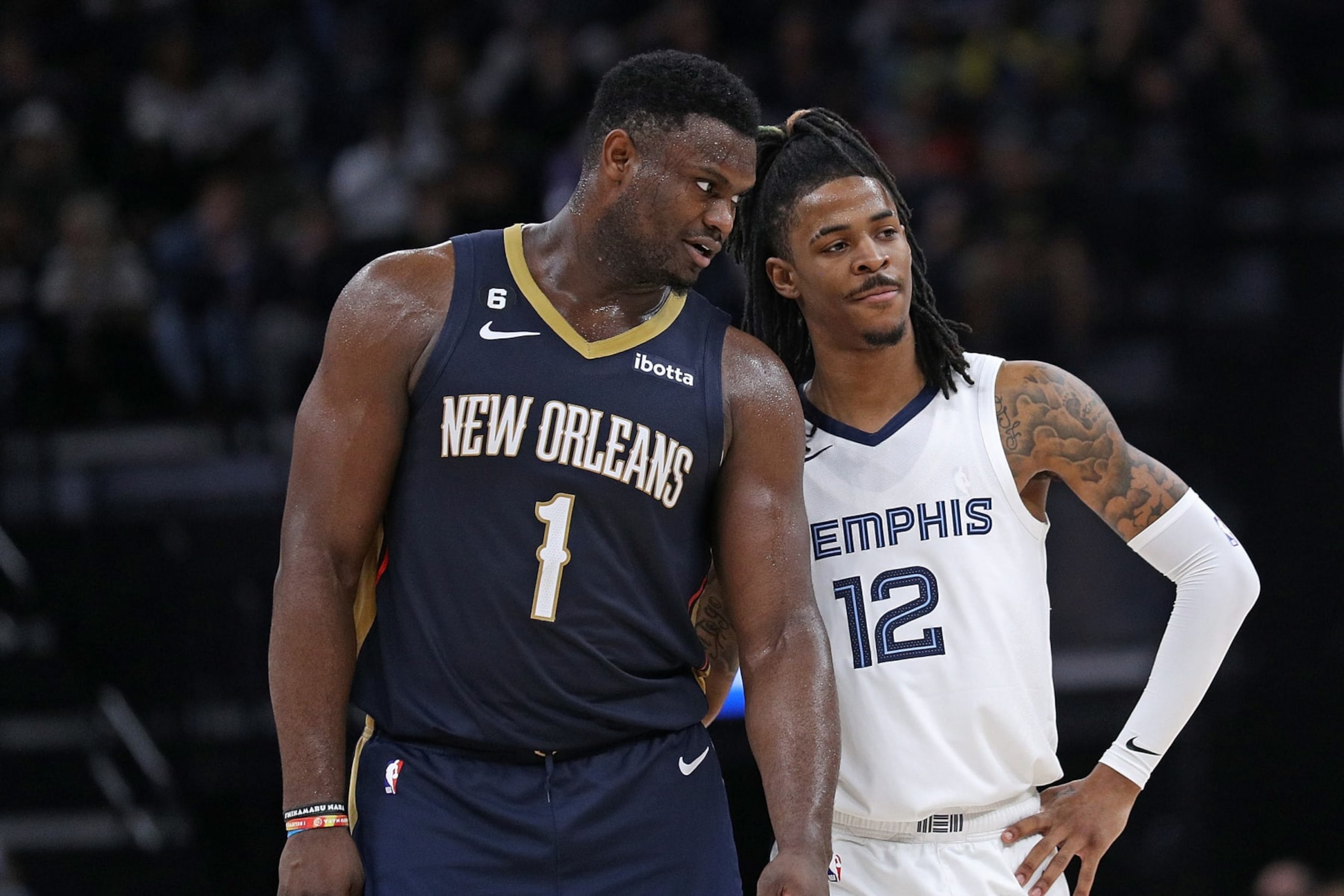 MEMPHIS, TENNESSEE - DECEMBER 31: Zion Williamson #1 of the New Orleans Pelicans and Ja Morant #12 of the Memphis Grizzlies during the game at FedExForum on December 31, 2022 in Memphis, Tennessee. NOTE TO USER: User expressly acknowledges and agrees that, by downloading and or using this photograph, User is consenting to the terms and conditions of the Getty Images License Agreement. (Photo by Justin Ford/Getty Images)