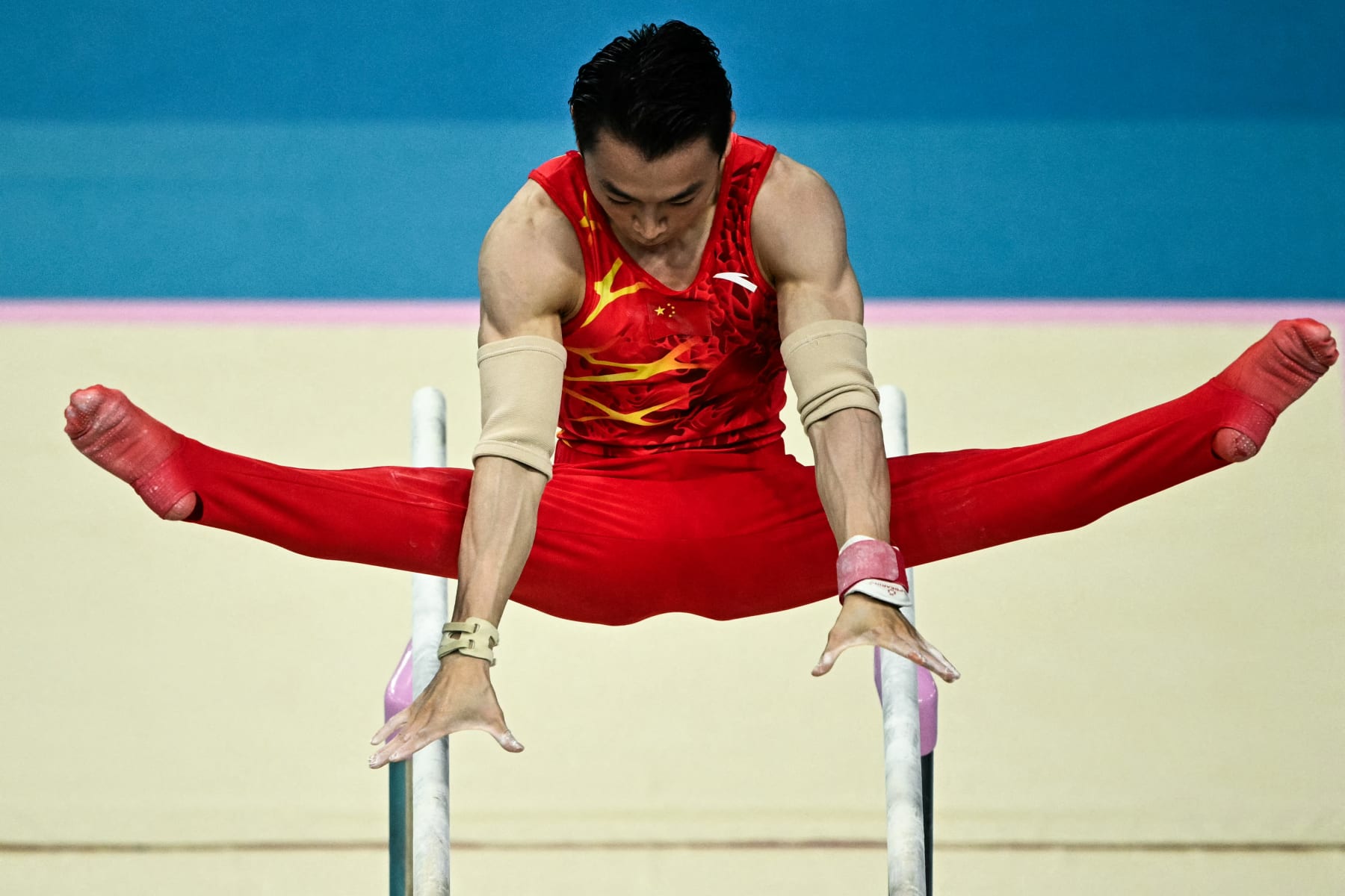 China's Zou Jingyuan competes in the artistic gymnastics men's parallel bars final during the Paris 2024 Olympic Games at the Bercy Arena in Paris, on August 5, 2024. (Photo by Lionel BONAVENTURE / AFP) (Photo by LIONEL BONAVENTURE/AFP via Getty Images)