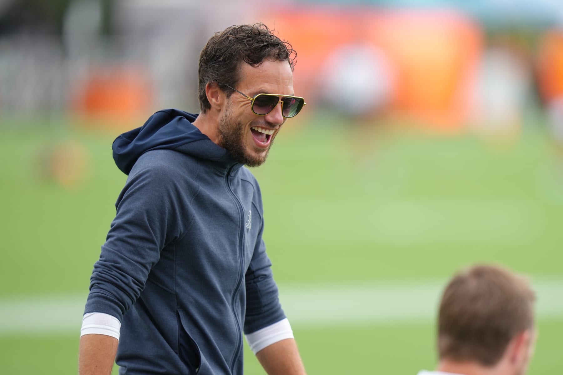 MIAMI GARDENS, FL - AUGUST 01: Miami Dolphins head coach Mike McDaniel shares a laugh with players during Dolphins Training Camp on Thursday, August 1, 2024 at Baptist Health Training Complex in Miami Gardens, Fla. (Photo by Peter Joneleit/Icon Sportswire via Getty Images)