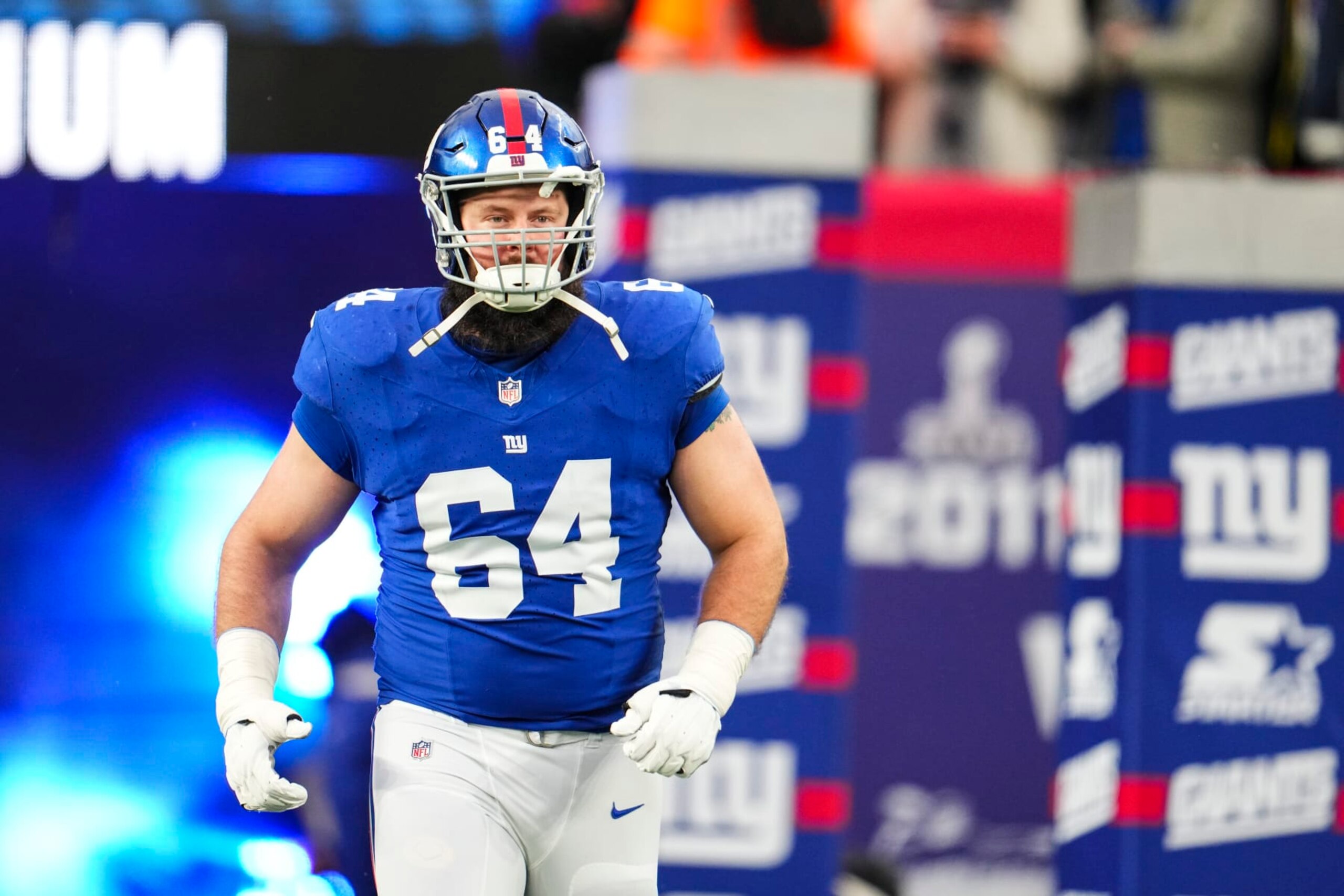 EAST RUTHERFORD, NJ - JANUARY 07: Mark Glowinski #64 of the New York Giants runs out of the tunnel prior to an NFL football game against the Philadelphia Eagles at MetLife Stadium on January 7, 2024 in East Rutherford, New Jersey. (Photo by Cooper Neill/Getty Images)