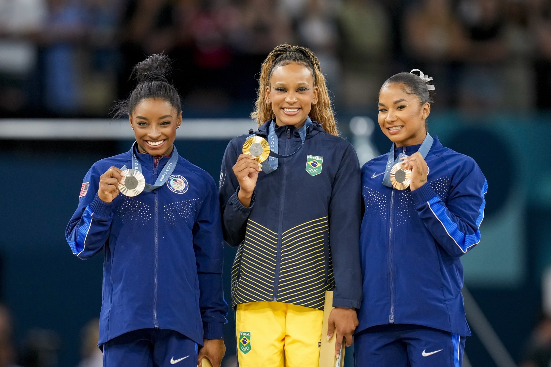 Silver medalist Simone Biles of USA, Gold medalist Rebeca Andrade of Brazil and Bronze medalists Jordan Chiles of USA celebrate during the Women's Artistic Gymnastics Floor Exercise Final medal ceremony on Day 10 of the Olympic Games Paris 2024 at Bercy Arena on August 5, 2024 in Paris, France. (Photo by Alex Gottschalk/DeFodi Images via Getty Images)