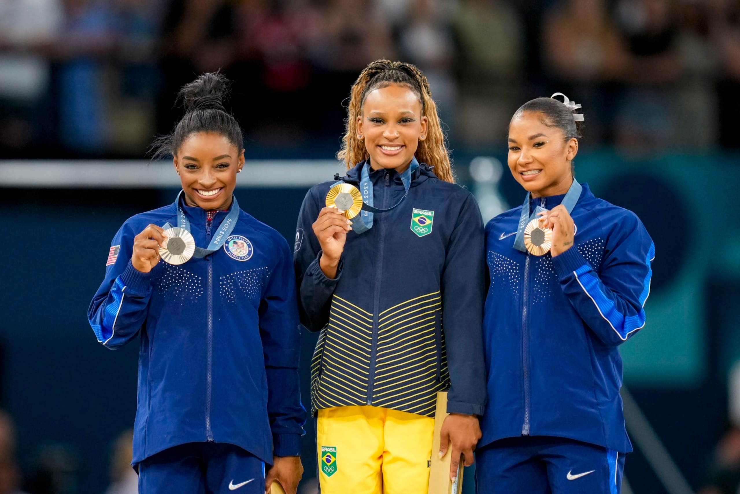 Silver medalist Simone Biles of USA, Gold medalist Rebeca Andrade of Brazil and Bronze medalists Jordan Chiles of USA celebrate during the Women's Artistic Gymnastics Floor Exercise Final medal ceremony on Day 10 of the Olympic Games Paris 2024 at Bercy Arena on August 5, 2024 in Paris, France. (Photo by Alex Gottschalk/DeFodi Images via Getty Images) Silver medalist Simone Biles of USA, Gold medalist Rebeca Andrade of Brazil and Bronze medalists Jordan Chiles of USA celebrate during the Women's Artistic Gymnastics Floor Exercise Final medal ceremony on Day 10 of the Olympic Games Paris 2024 at Bercy Arena on August 5, 2024 in Paris, France. (Photo by Alex Gottschalk/DeFodi Images via Getty Images)
