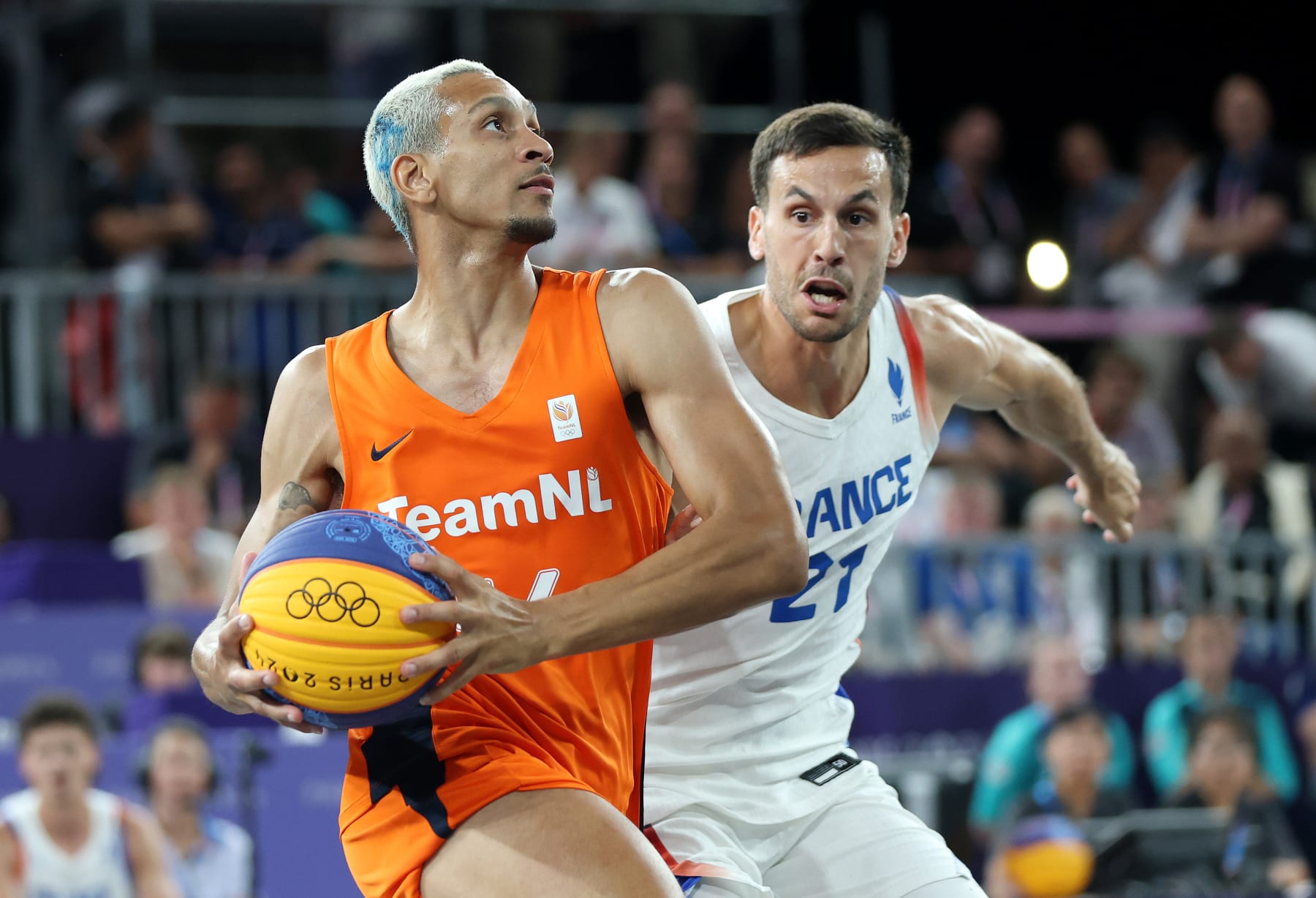 PARIS, FRANCE - AUGUST 05: Worthy de Jong #54 of Team Netherlands drives past Franck Seguela #21 of Team France during a Men's 3x3 basketball Gold medal game between the Netherlands and France on day ten of the Olympic Games Paris 2024 at Esplanade Des Invalides on August 05, 2024 in Paris, France. (Photo by Matthew Stockman/Getty Images)