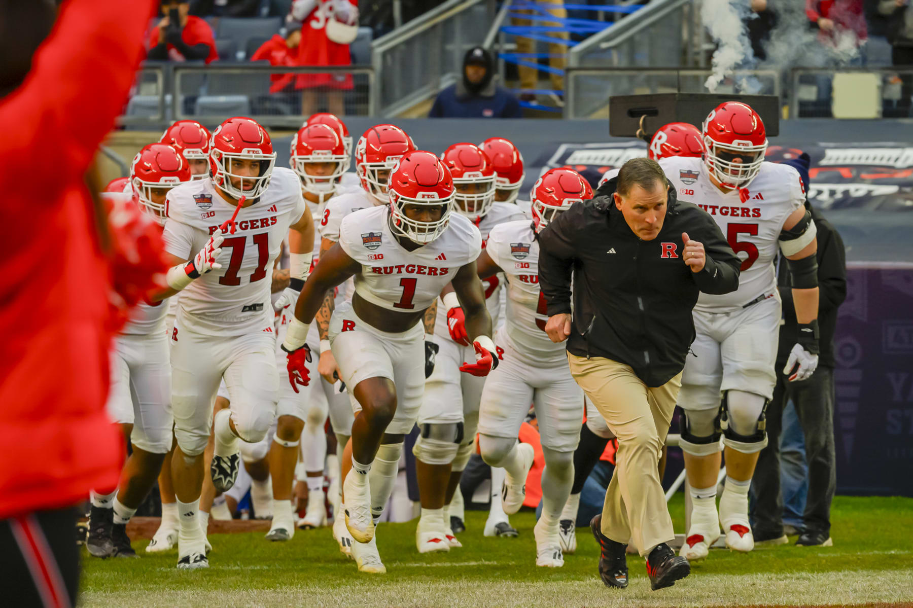NEW YORK, NEW YORK - DECEMBER 28: Rutgers Head Coach Greg Schiano leads his team on the field before a game between Rutgers University and University of Miami at Yankee Stadium on December 28, 2023 in New York, New York. (Photo by James Patrick Cooper/ISI Photos/Getty Images)