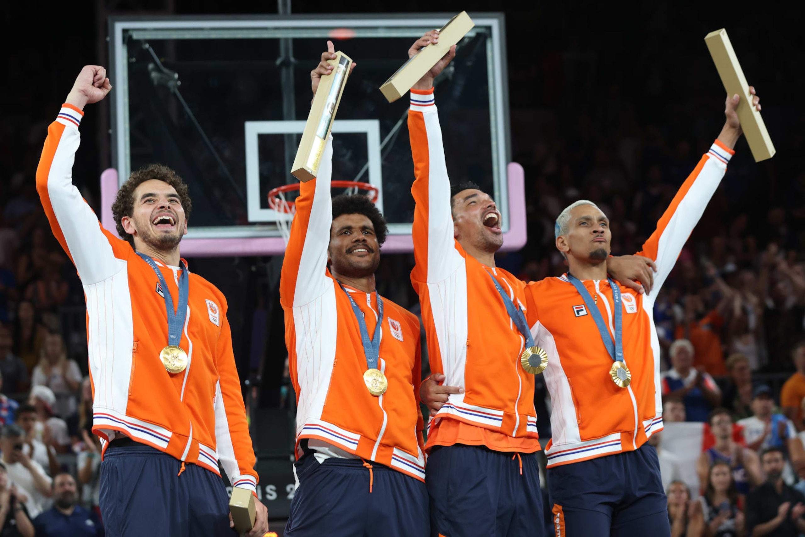 PARIS, FRANCE - AUGUST 05: Men's 3x3 basketball Gold medalists Jan Driessen, Dimeo van der Horst, Arvin Slagter, and Worthy de Jong of Team Netherlands celebrate during the medal ceremony for Men's 3x3 basketball on day ten of the Olympic Games Paris 2024 at Esplanade Des Invalides on August 05, 2024 in Paris, France. (Photo by Matthew Stockman/Getty Images)