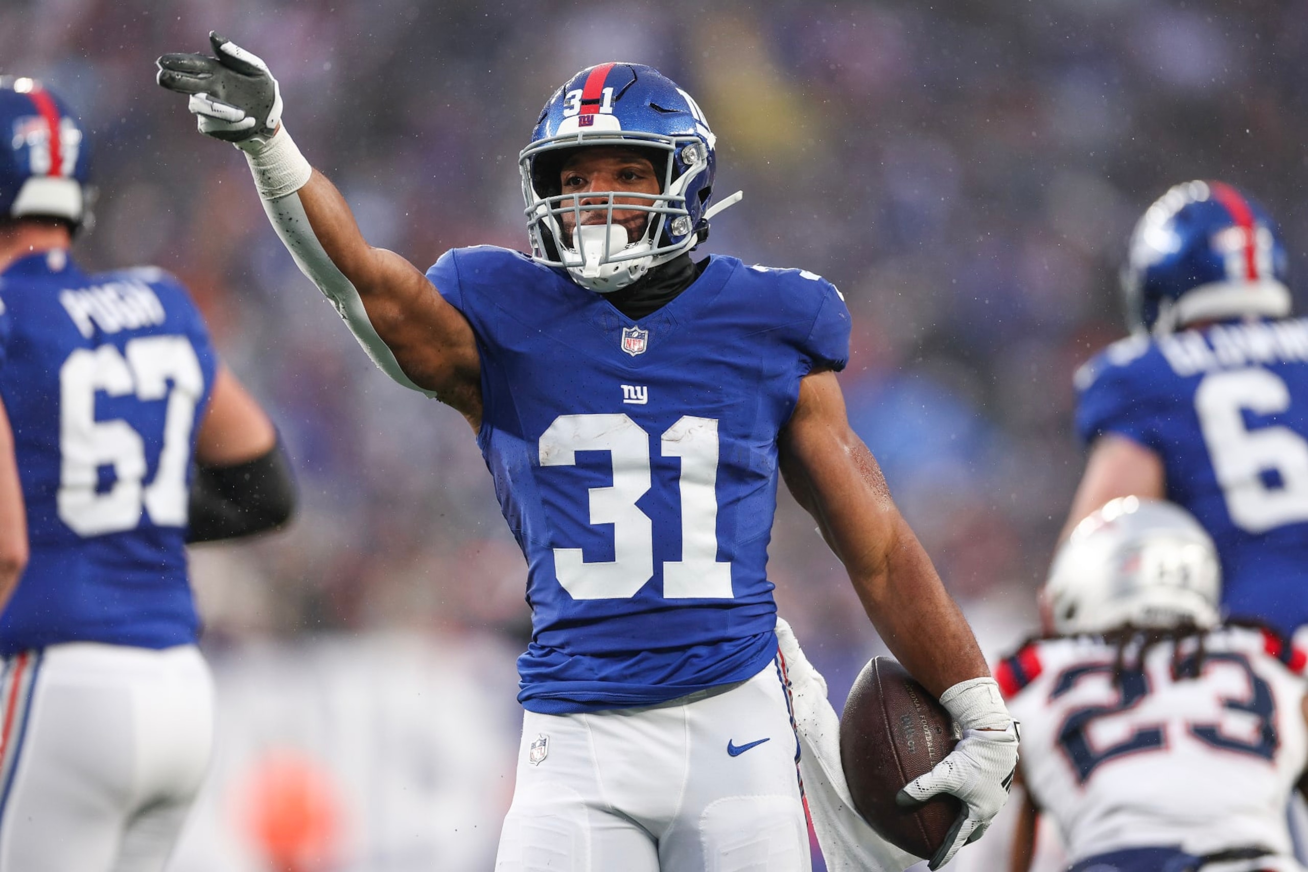EAST RUTHERFORD, NEW JERSEY - NOVEMBER 26: Matt Breida #31 of the New York Giants signals for a first down during the fourth quarter against the New England Patriots at MetLife Stadium on November 26, 2023 in East Rutherford, New Jersey. (Photo by Elsa/Getty Images)