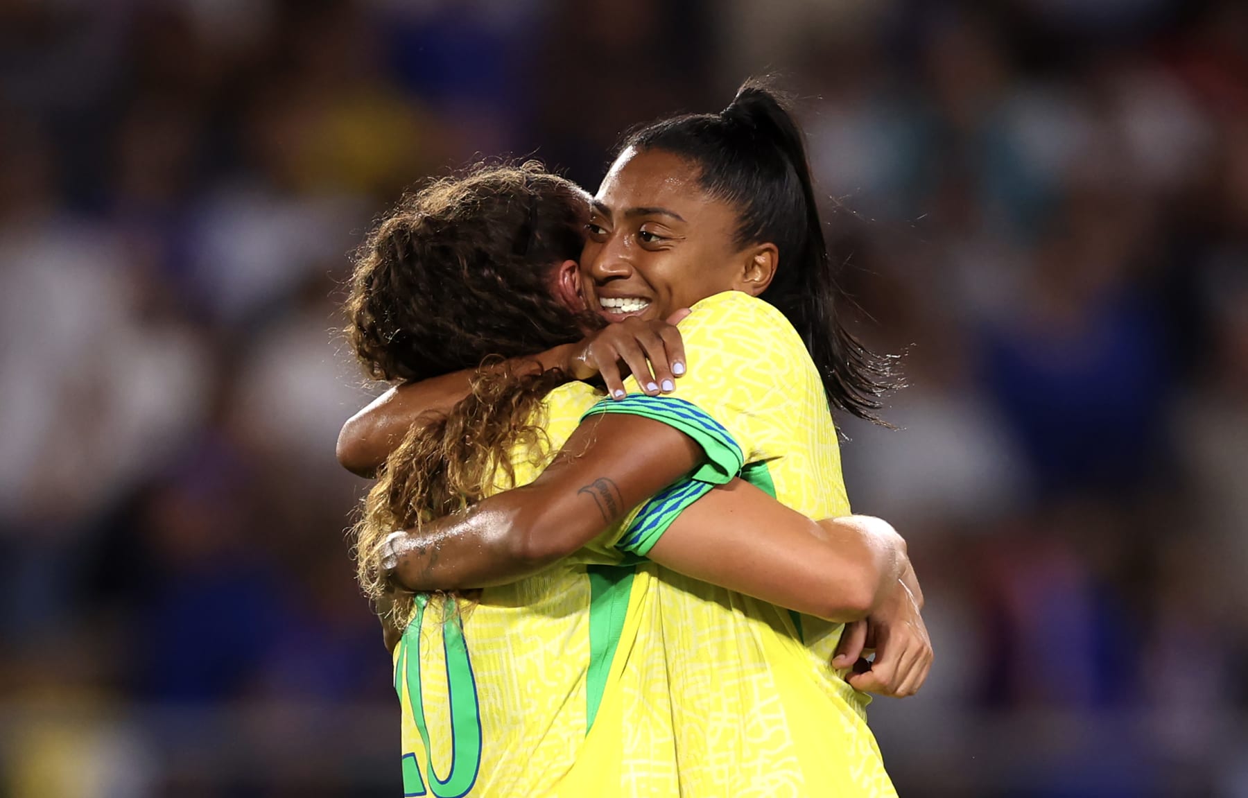 NANTES, FRANCE - AUGUST 03: Angelina #20 of Team Brazil celebrates victory with teammate after the Women's Quarterfinal match between France and Brazil during the Olympic Games Paris 2024 at Stade de la Beaujoire on August 03, 2024 in Nantes, France. (Photo by Robert Cianflone/Getty Images)