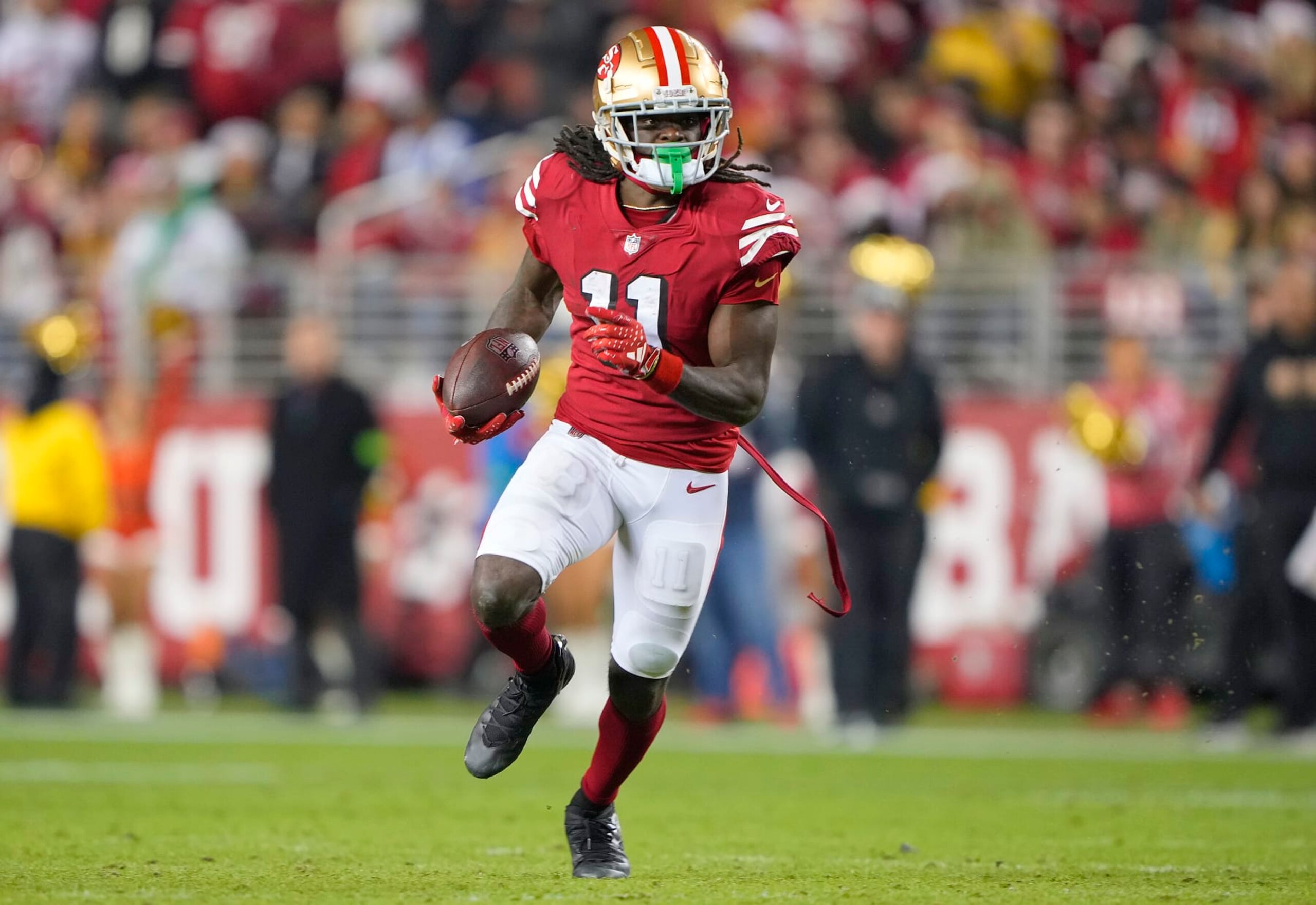 SANTA CLARA, CALIFORNIA - DECEMBER 25: Brandon Aiyuk #11 of the San Francisco 49ers runs with the ball after catching a pass against the Baltimore Ravens during the fourth quarter of an NFL football game at Levi's Stadium on December 25, 2023 in Santa Clara, California. (Photo by Thearon W. Henderson/Getty Images)