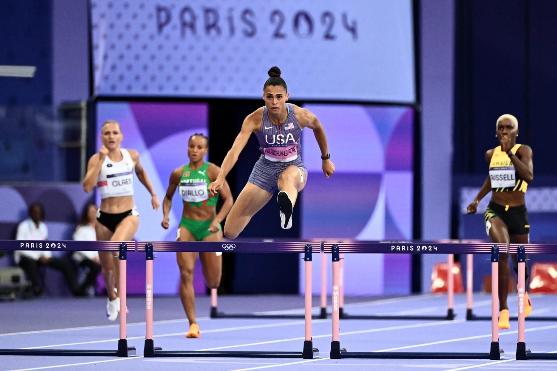 US' Sydney Mclaughlin-Levrone crosses a hurdle in the women's 400m hurdles semi-final of the athletics event at the Paris 2024 Olympic Games at Stade de France in Saint-Denis, north of Paris, on August 6, 2024. (Photo by Jewel SAMAD / AFP) (Photo by JEWEL SAMAD/AFP via Getty Images)