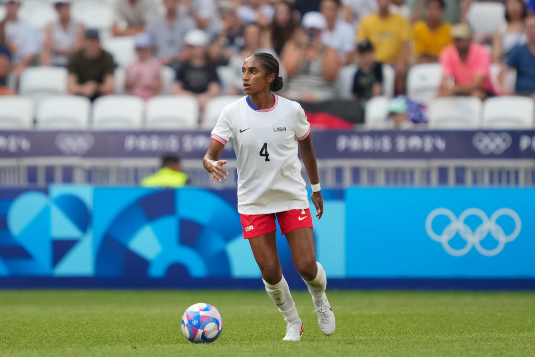 LYON, FRANCE - AUGUST 06: Naomi Girma #4 of the United States on the ball during the first half against Germany during the Women's semifinal match during the Olympic Games Paris 2024 at Stade de Lyon on August 06, 2024 in Lyon, France. (Photo by John Todd/ISI/Getty Images)