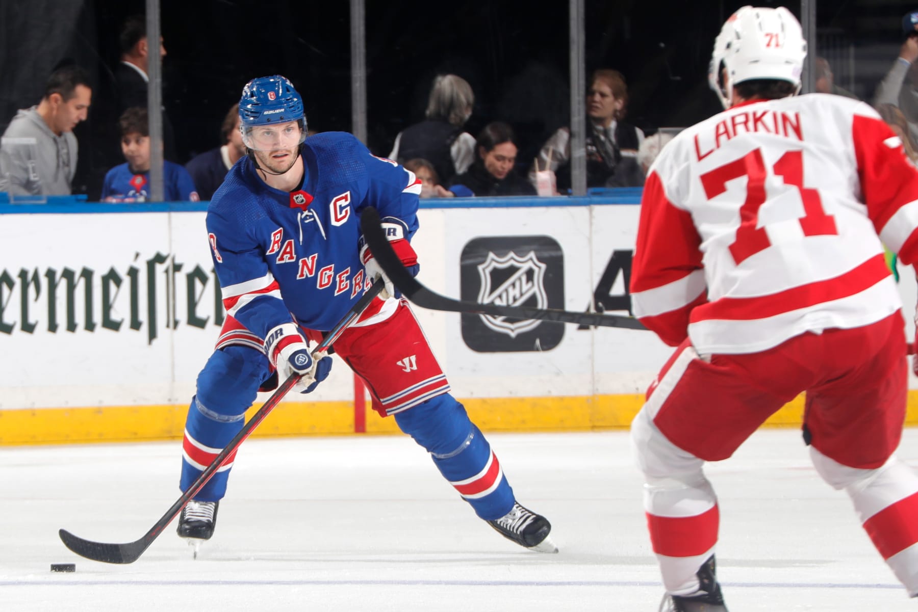 NEW YORK, NEW YORK - NOVEMBER 06:  Jacob Trouba #8 of the New York Rangers skates with the puck against Dylan Larkin #71 of the Detroit Red Wings at Madison Square Garden on November 6, 2022 in New York City. (Photo by Jared Silber/NHLI via Getty Images)