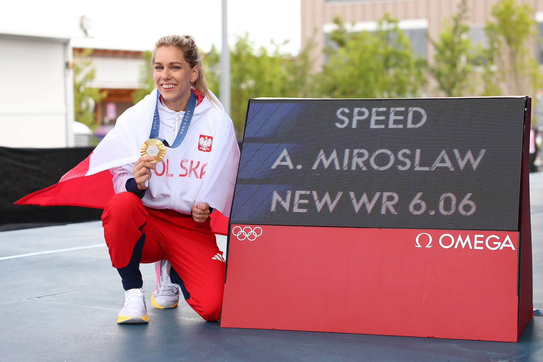 PARIS, FRANCE - AUGUST 07: Gold medalist Aleksandra Miroslaw of Team Poland poses with the medal and a sign displaying her World Record after the Women's Speed, Final on day twelve of the Olympic Games Paris 2024 at Le Bourget Sport Climbing Venue on August 07, 2024 in Paris, France. (Photo by Michael Reaves/Getty Images)