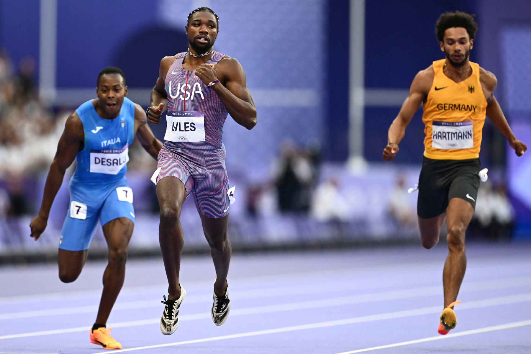 Italy's Eseosa Fostine Desalu, US' Noah Lyles and Germany's Joshua Hartmann compete in the men's 200m semi-final of the athletics event at the Paris 2024 Olympic Games at Stade de France in Saint-Denis, north of Paris, on August 7, 2024. (Photo by Jewel SAMAD / AFP) (Photo by JEWEL SAMAD/AFP via Getty Images)