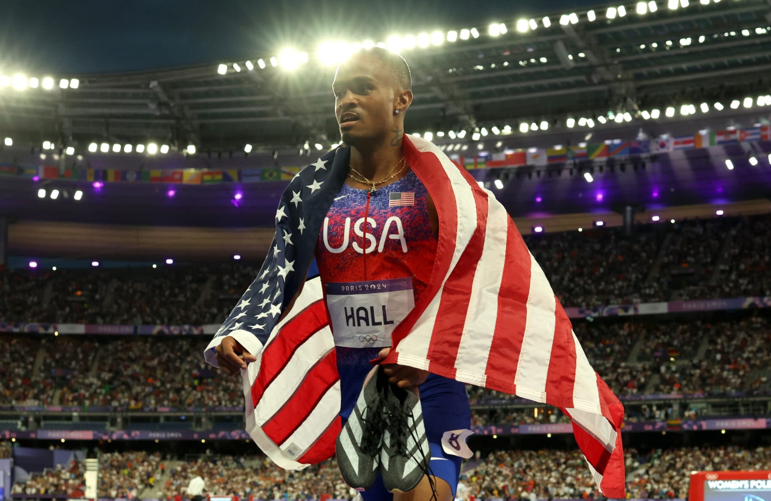 PARIS, FRANCE - AUGUST 07: Quincy Hall of Team United States celebrates with the stars and stripes after winning the Men's 400m final on day twelve of the Olympic Games Paris 2024 at Stade de France on August 07, 2024 in Paris, France. (Photo by Richard Heathcote/Getty Images)